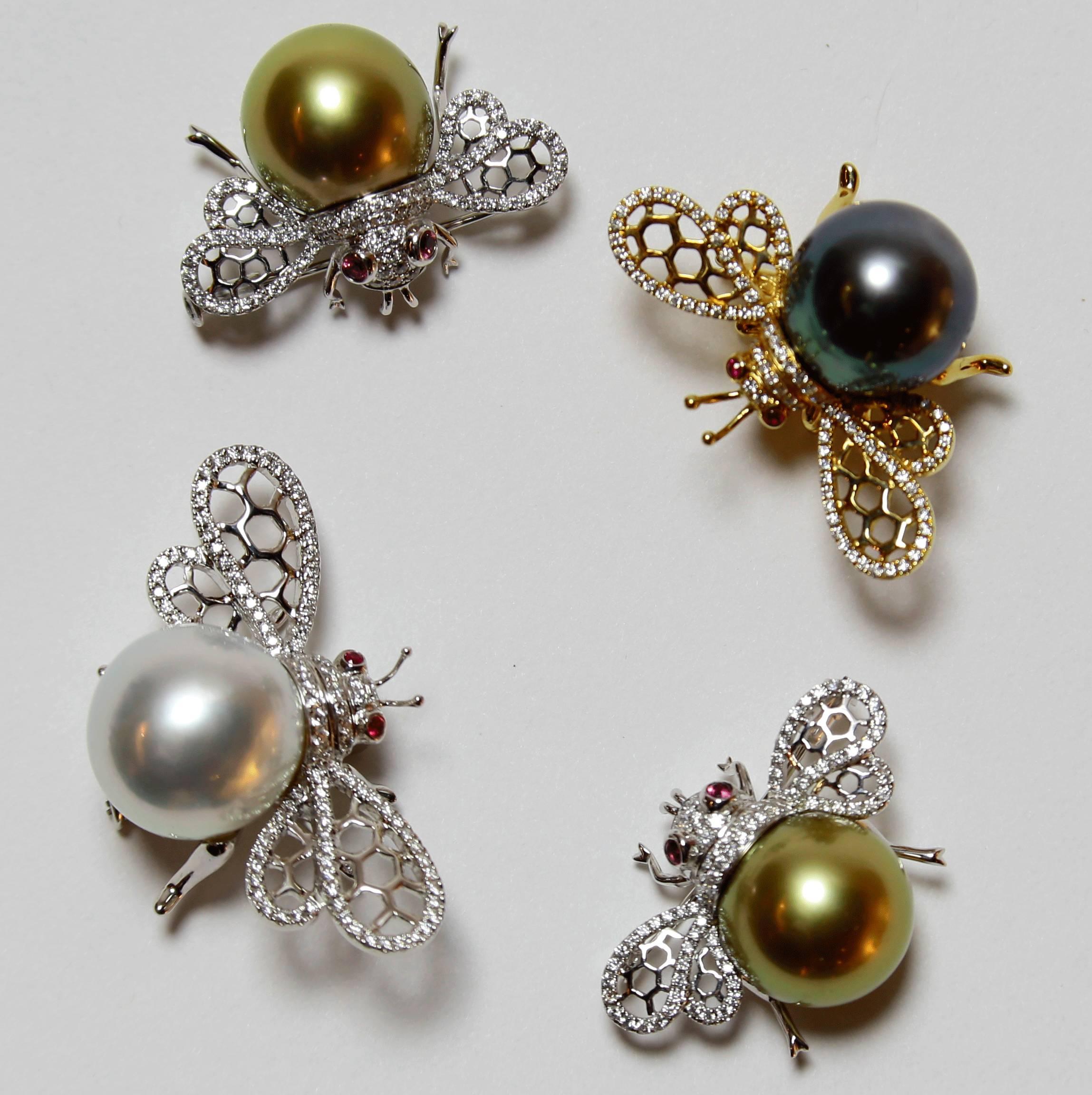 Two Elegant & Finely detailed vintage Bumble Bee pins, each set with approximately 0.3747ctw in G/VS diamonds, enhancing the wings and body, a 14.2mm Gold South Sea Pearl and two Ruby eyes; 18 Karat white gold; each pin measures approx. 29.7mm x