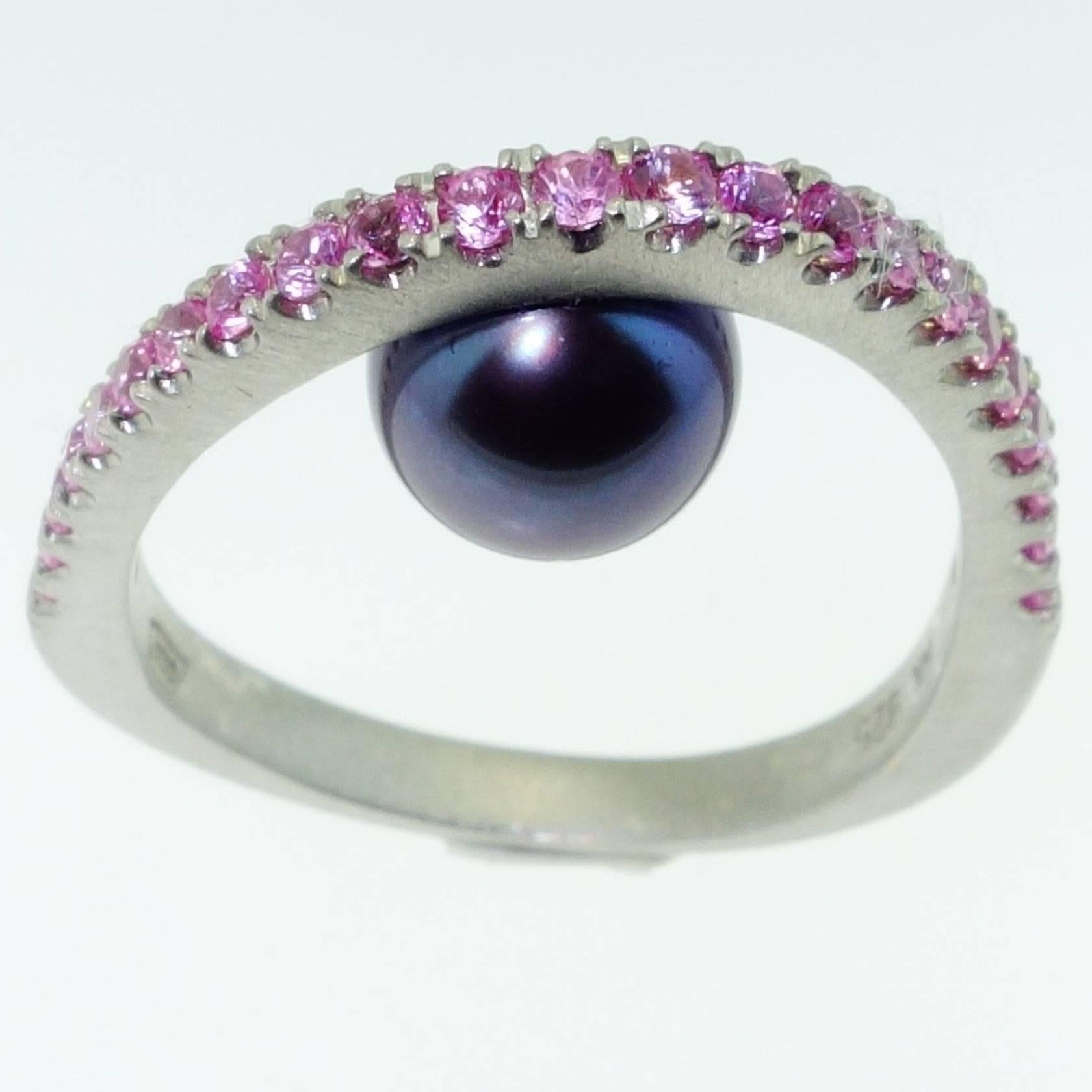With a Black Peacock freshwater pearl below; top of ring enhanced with Pink Sapphires; approx. 0.70tctw; Sterling Silver Tarnish-resistant Rhodium mounting; Size 8, we offer ring re-sizing. More fabulous in person! A Striking Statement, Stylish and