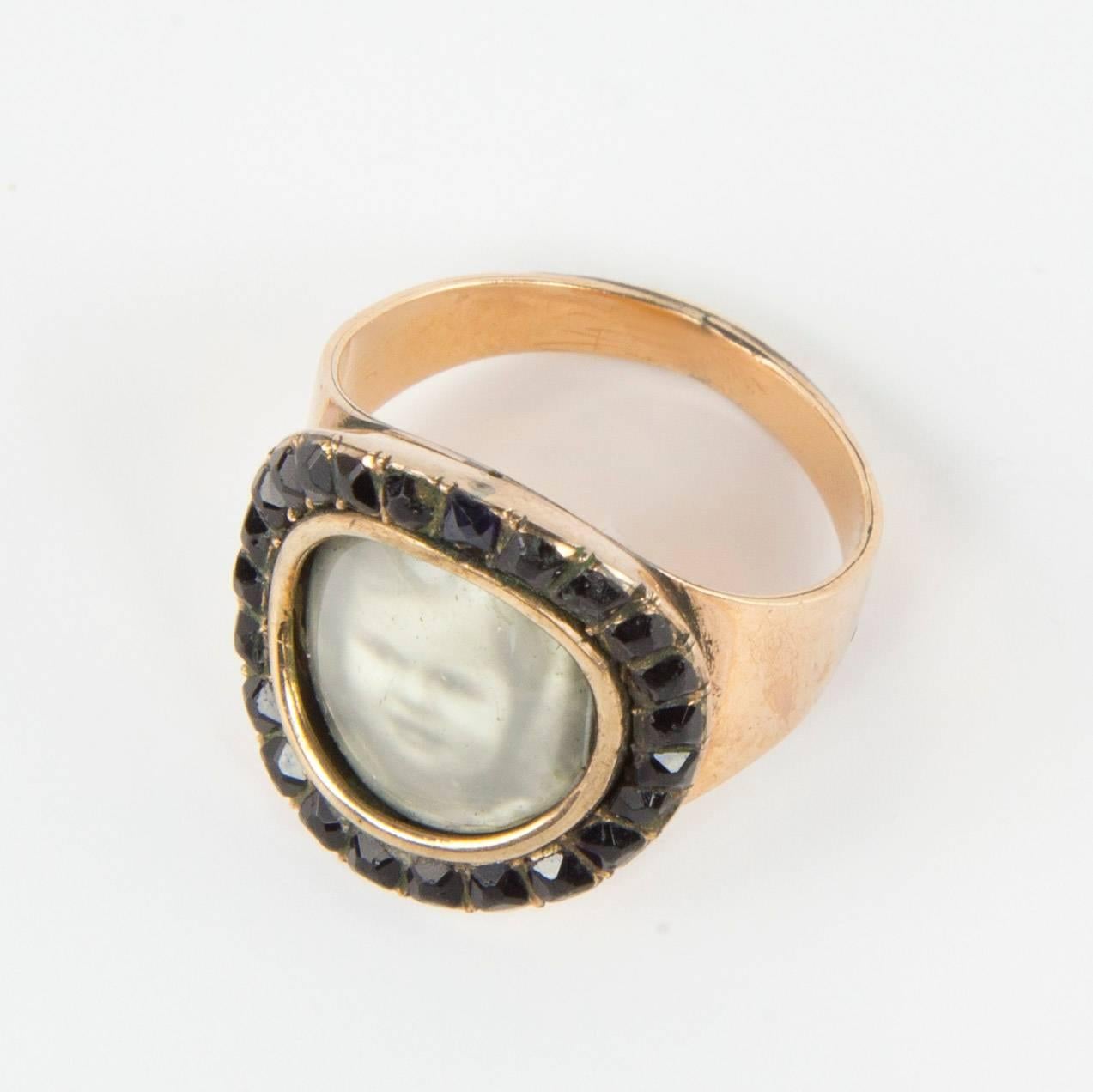 Belle Époque era Heirloom mourning ring features an antique photo portrait of a young girl fitted perfectly inside; set in Rose Gold and bordered with 24 Jet stones. The band is composed of 14k rose gold; Size: 6. The ring is just as lovely today as