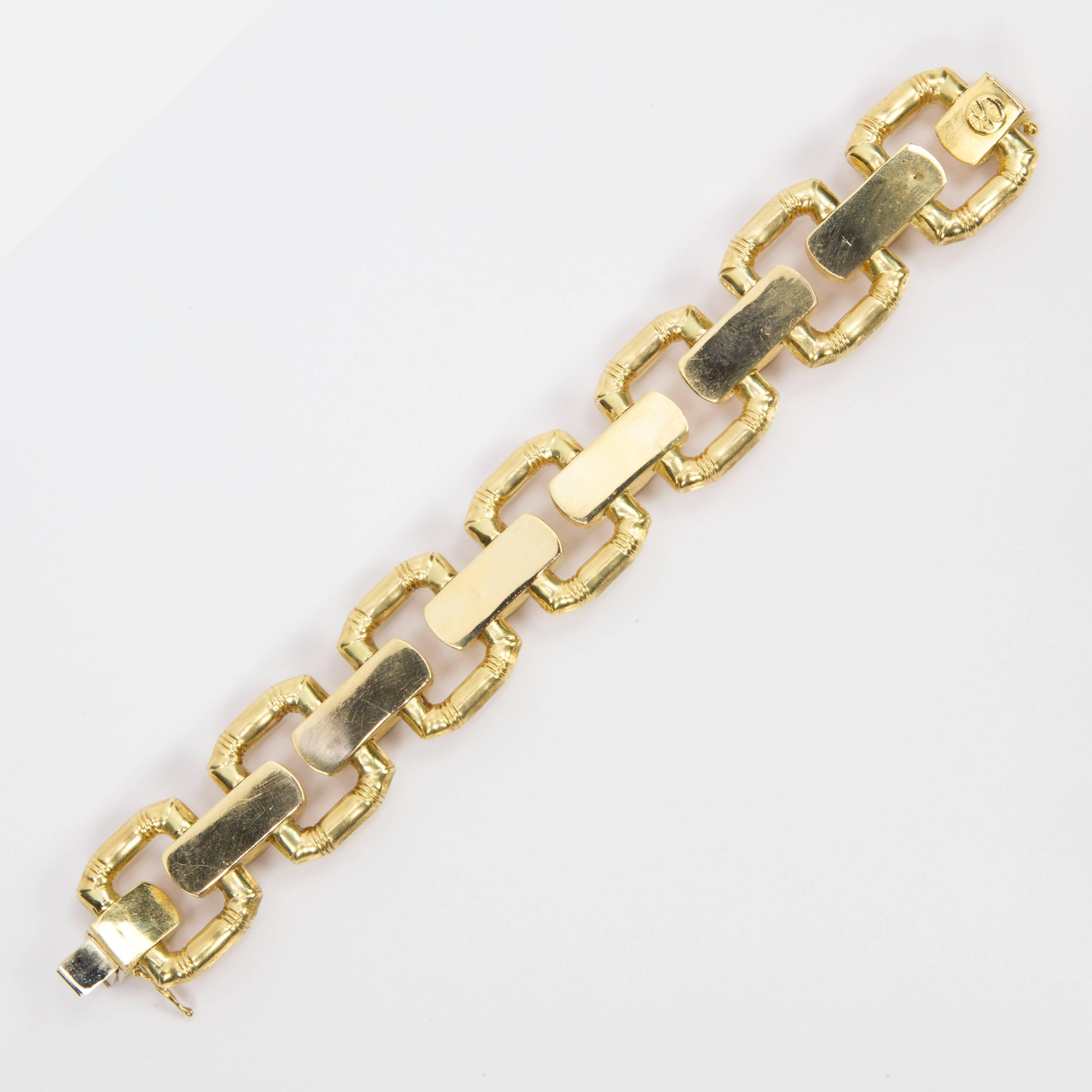 Bold Modernist Gate Link Runway Bracelet features seven large links inter-spaced with rectangular tube panels, creating a streamlined effect. Brushed finish; Handcrafted; It measures 7.5" in length by 1" wide; hidden clasp closure; marked: