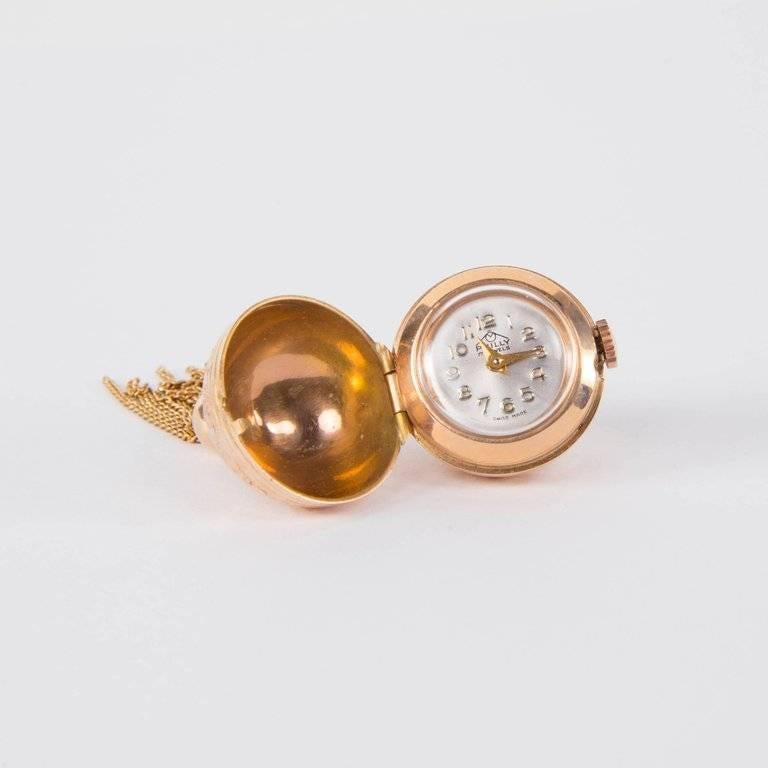 Beautiful Modernist Pendant Ball Watch suspending multi-stand tassel; exquisitely made Swiss made by the fine jeweler Philly; overall Body is gold with beautifully worked engraved designs; 17 jewel Swiss manual wind movement. 2.25” long x .75”