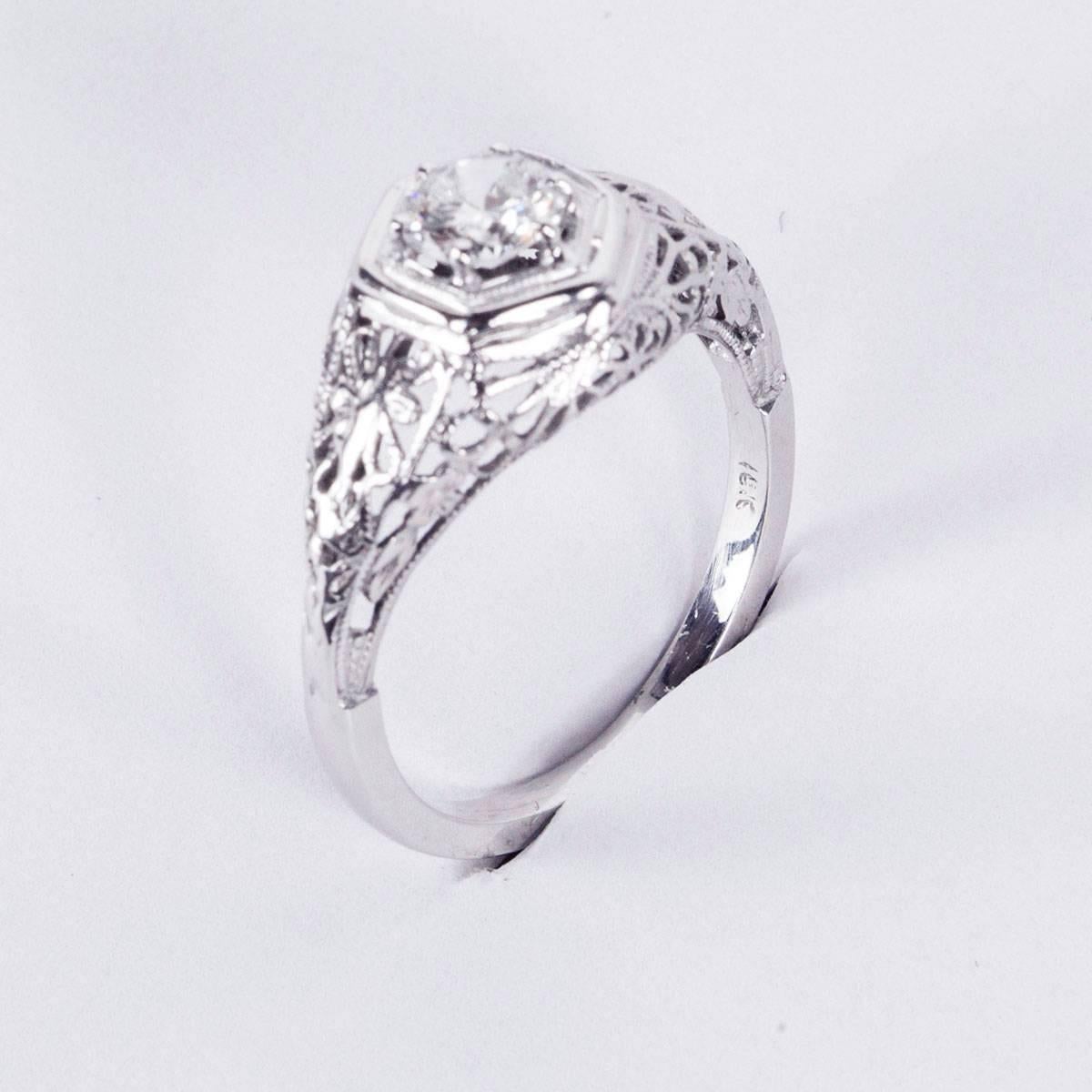 Beautiful Art Deco Diamond Engagement Ring centering a Brilliant cut Diamond, approx. 0.45 carat; wonderful H color and VS2 clarity, milgrain setting; shank is 18K and top mounting in platinum featuring elaborate chase work, making it a Special and