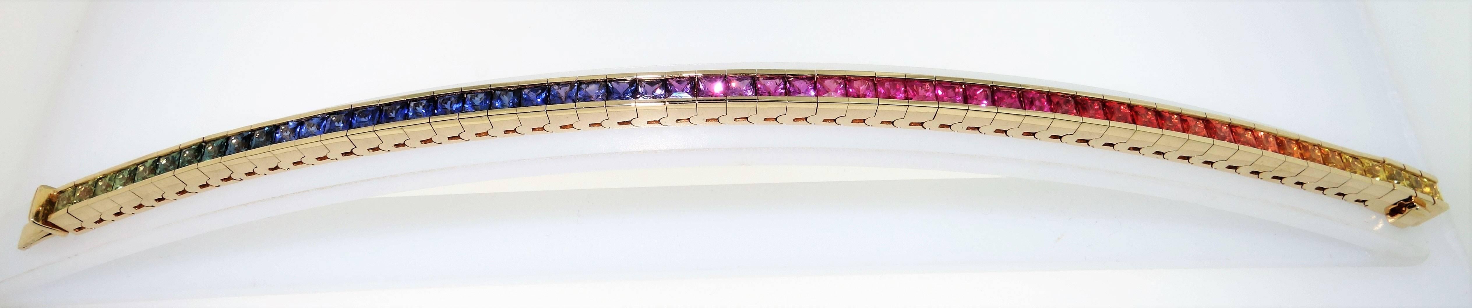 Simply fabulous Princess cut Multi-color Sapphire line tennis bracelet; 12.71 Carat Colors of the Rainbow of 3.3mm stones, set in 18k yellow gold. Approx. Bracelet measures approx. 7 inches long x .25 inches wide. Classic and so easy to