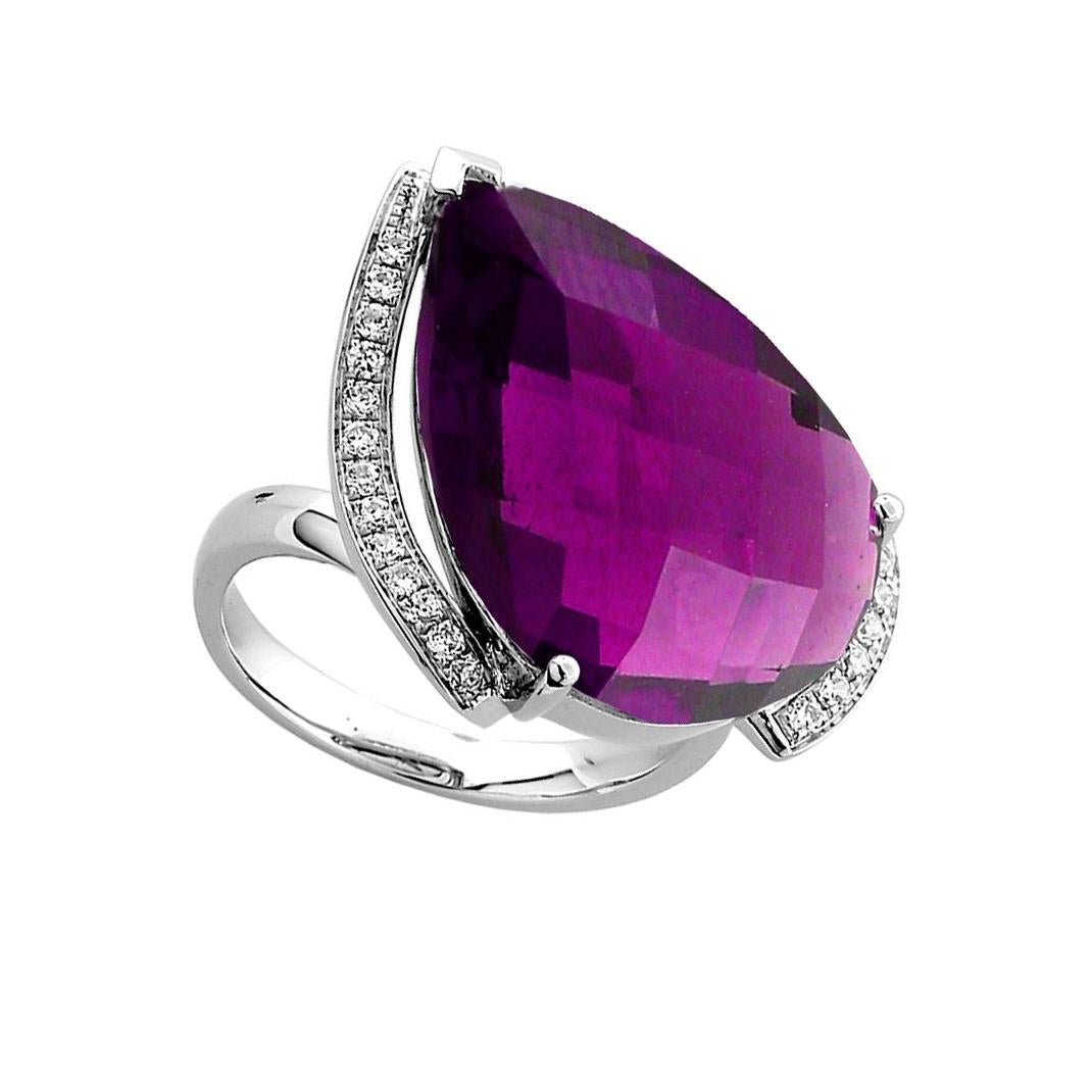 Fabulous 15.55 Carat Amethyst ring surrounded by thirty-three round brilliant-cut Diamonds, weighing approx. 0.264 ct., teardrop facet-cut Amethyst measures approx. 20mm x 15mm; mounted in 14k white gold. Ring size: 7. More Beautiful in real