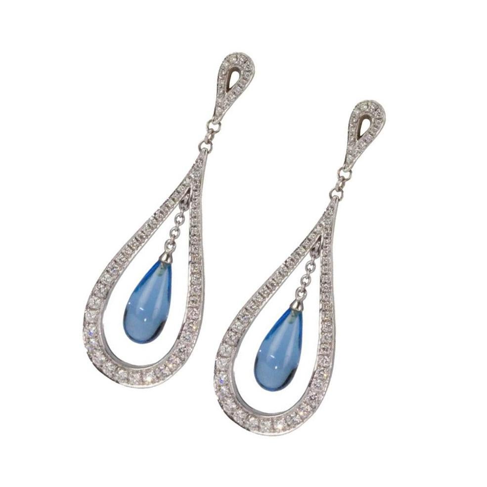 Simply beautiful and elegant Diamond and Blue Topaz Drop Earrings; pave round brilliant cut diamonds on posts, suspending elongated Torpedo shaped Blue Topaz  stones,   mounted in handmade 14k white gold; An overall fun and fine pair of earrings.