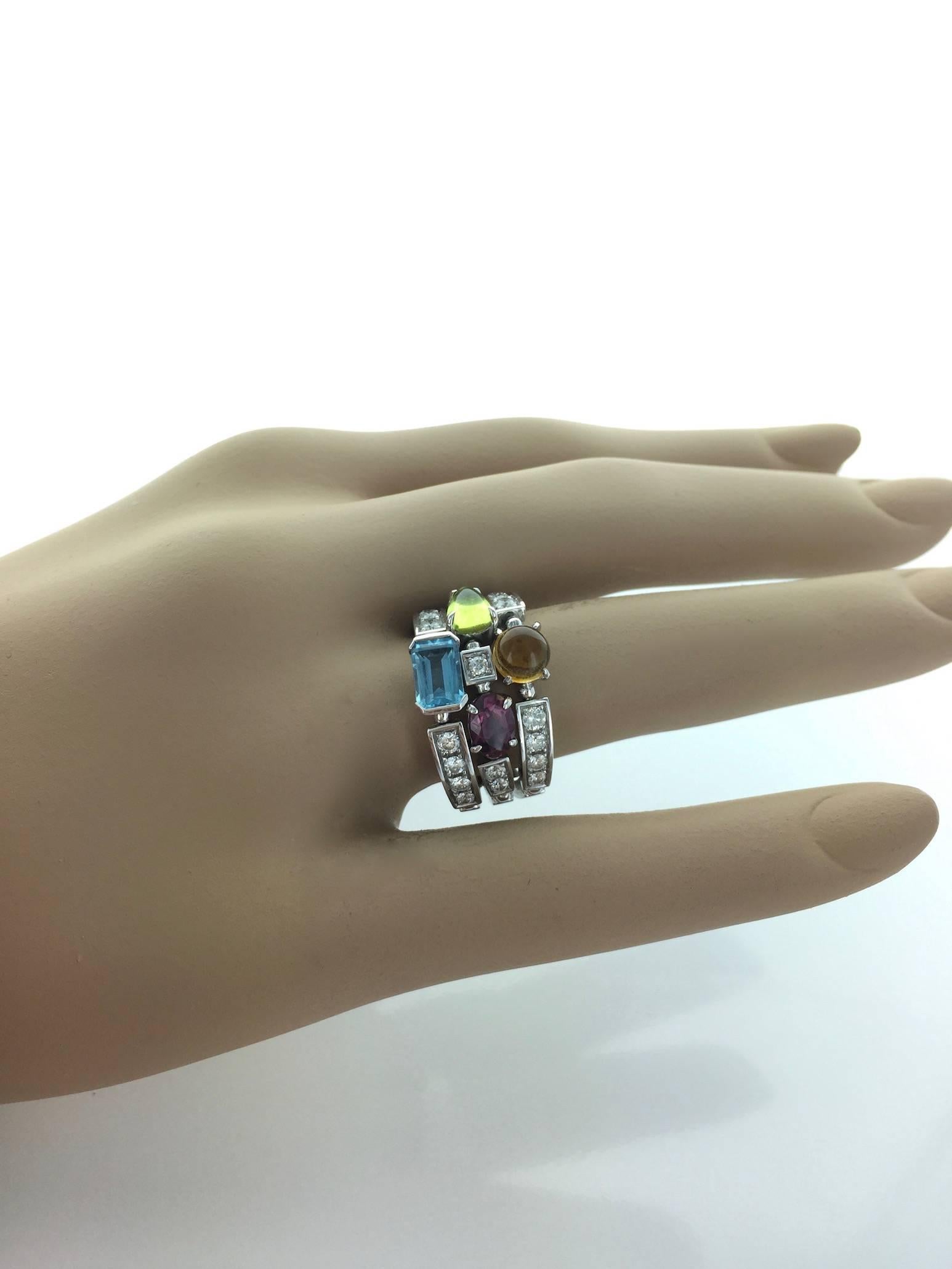 A classical tasteful Bulgari creation Allegra ring colorful and joyful.
Color collection 3-band 18k 750 white gold ring with pink tourmaline, peridot, citrine quartz, blue topaz and pavé diamonds.

Signed Bulgari. 
Made in Italy.
Size: 7 3/4 Us