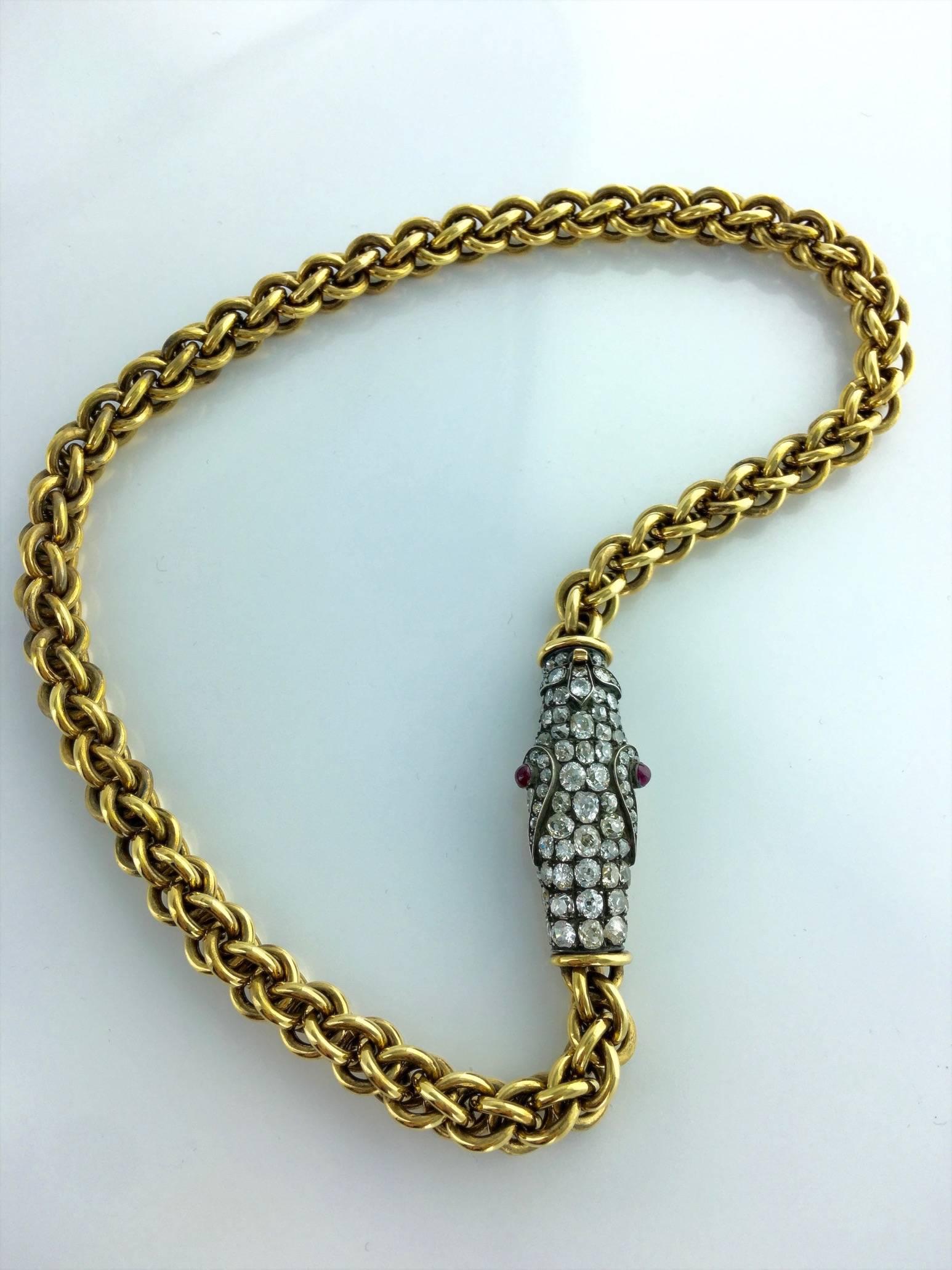 Fantastic Snake Necklace. Strong and significant, the chain is in yellow gold 18k 750 and the Snake's head is in silver and gold engraved, all pave on the top by Old-mine cut Diamond. The eyes are cabochon rubies.

Total Diamond weight: