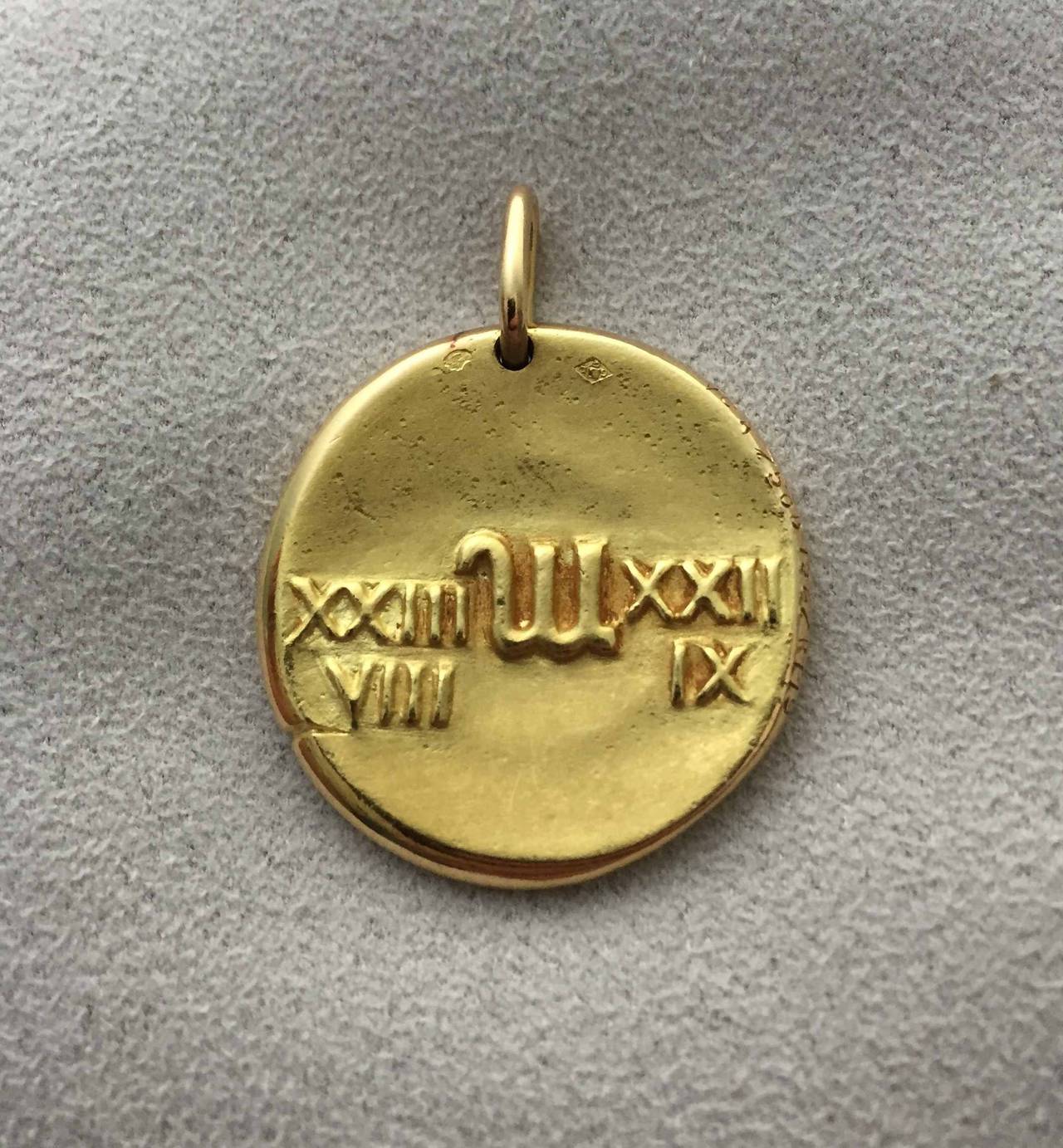 Estate Van Cleef & Arpels 18k Gold Virgo Zodiac Pendant.

Vintage Virgo zodiac medallion pendant in 18k yellow gold, designed to resemble an ancient coin, depicting a unicorn beside a standing woman on the front and Roman numerals with symbol for