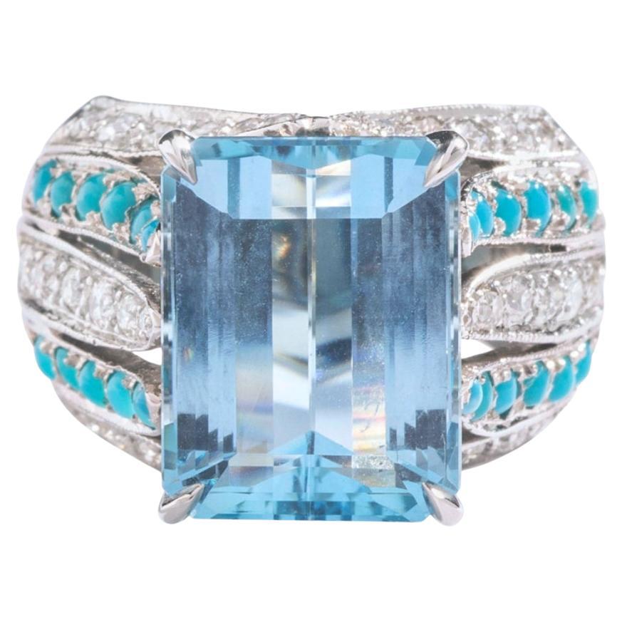 9.75 carat Aquamarine centering a diamond and cabochon turquoise platinum ring.
Circa 1970.