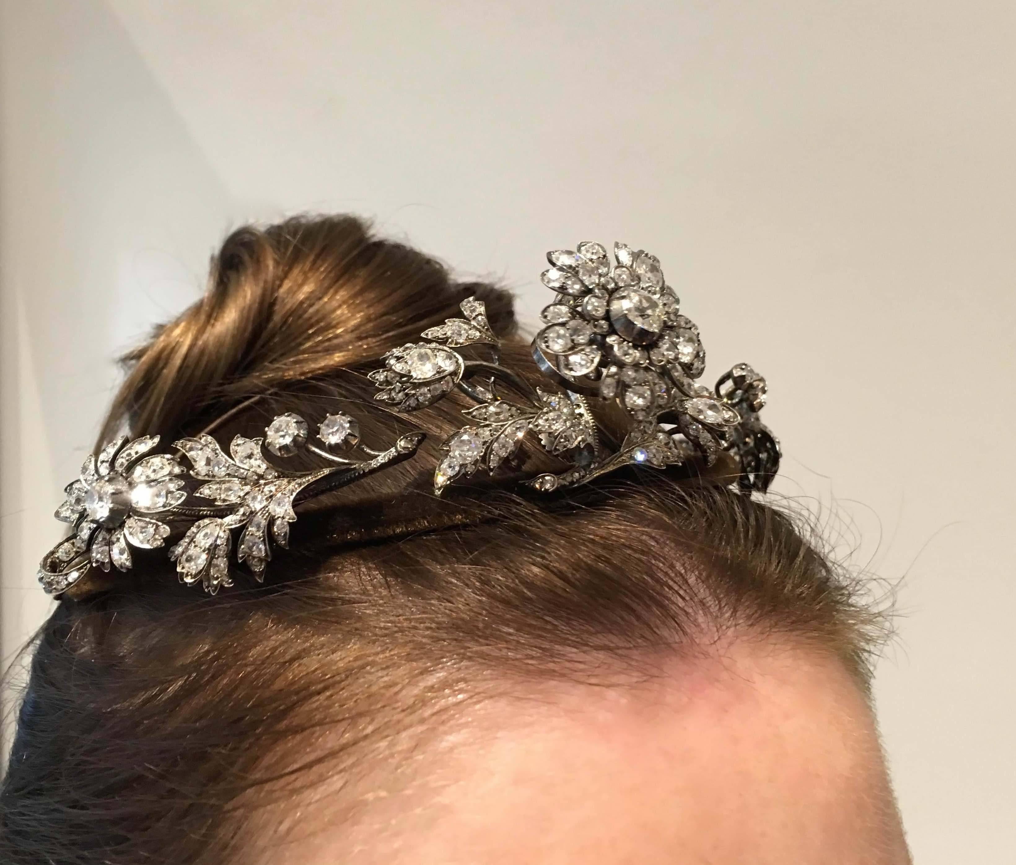 Diamond Tiara designed as a floral spray, the central flower en tremblant, with circular-cut, cushion-, pear-shaped, oval and rose diamonds, detachable tiara frame, three brooch clip fittings.
Mounted in silver and backed in gold. Frame covered with