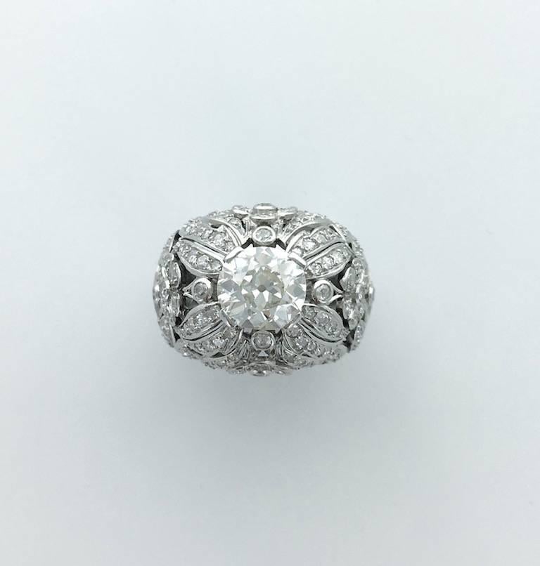 This is Magic! This piece is impressive and beautiful all in Platinum and diamond.

Round-cut diamond weight: approximately 2.00 carats.
Centered by a Cushion-shape diamond: approximately 2.50 carats 
(Our opinion color K purity Si1).
Circa