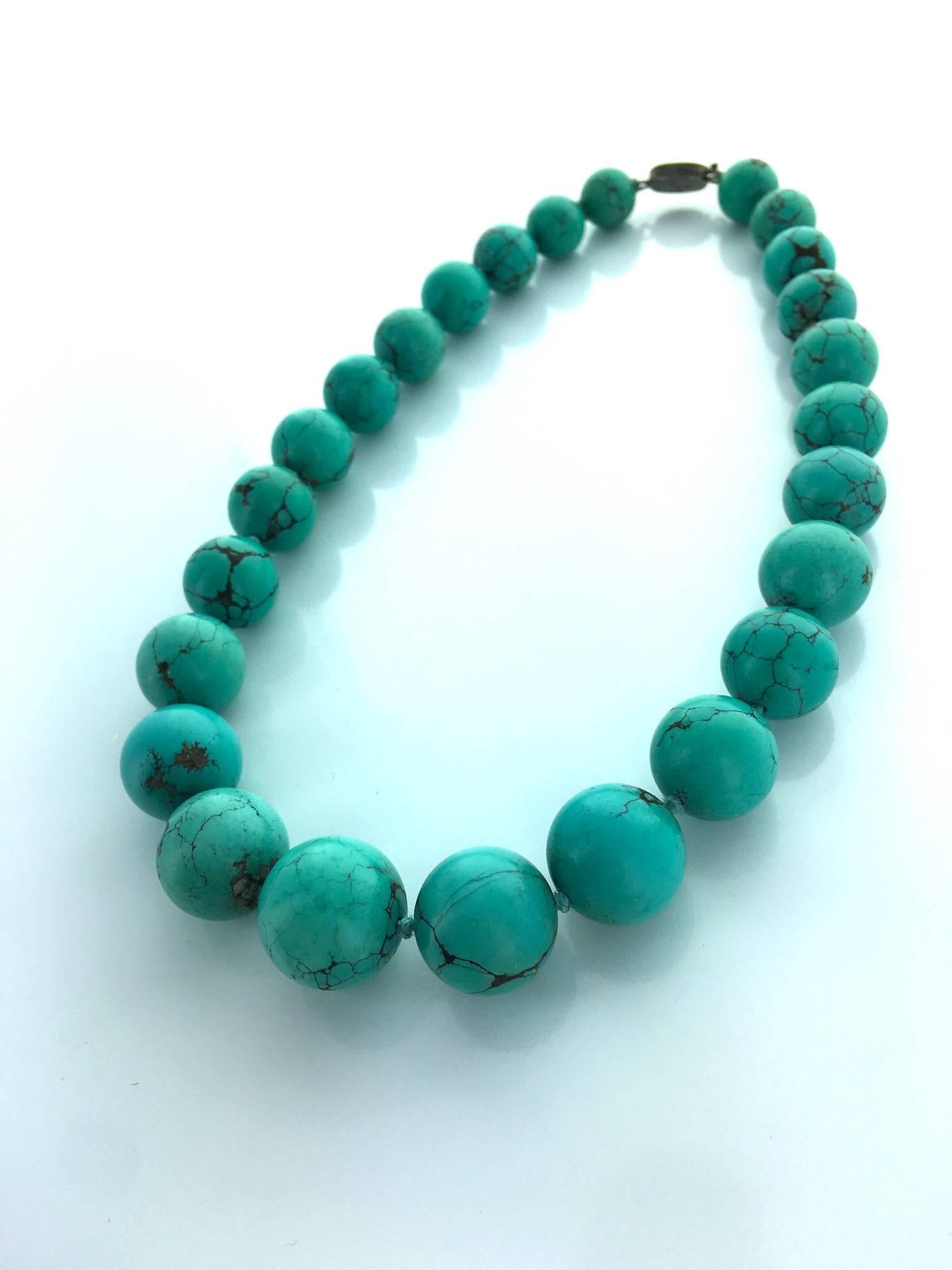 Rare Antique necklace gathering impressive volume Turquoise matrix ball.
Diameter from 0.43 to 0.71 inch. (11 to 18 millimeters).
Perfect color and condition. 
Circa 1900.
Origin: Central Asia.

Total length: 18.90 inches (48.00 centimeters).
Clasp