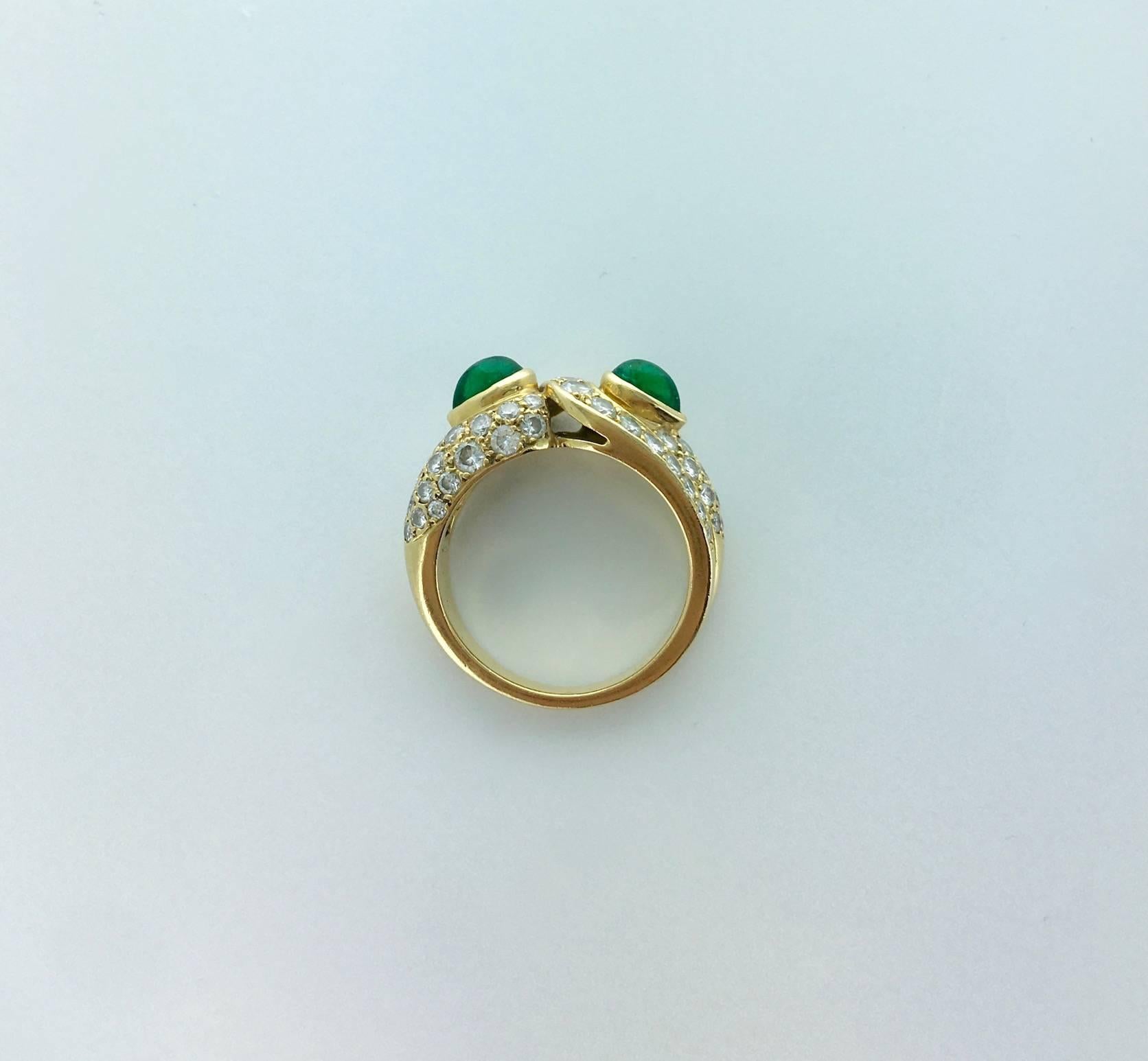 A beautifully designed two cabochon Pear-shape Emerald and diamond pave mounted on yellow gold 18k 750 ring.
Circa 1980.
French assay marks and maker's mark.
Signed Boucheron, numbered.

Gross weight: 7.53 grams
