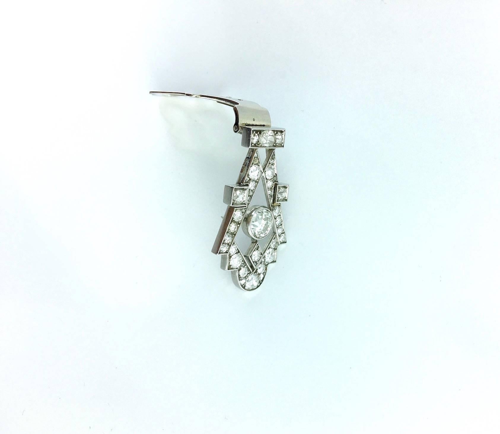 Art Deco's strong design is mesmerizing. This Diamond and Platinum clip is convertible on a post realized cultured pearl necklace.
Russian marks 585 14k white gold for the system.
The clip brooch is circa 1930.

Gross weight: 9.69 grams