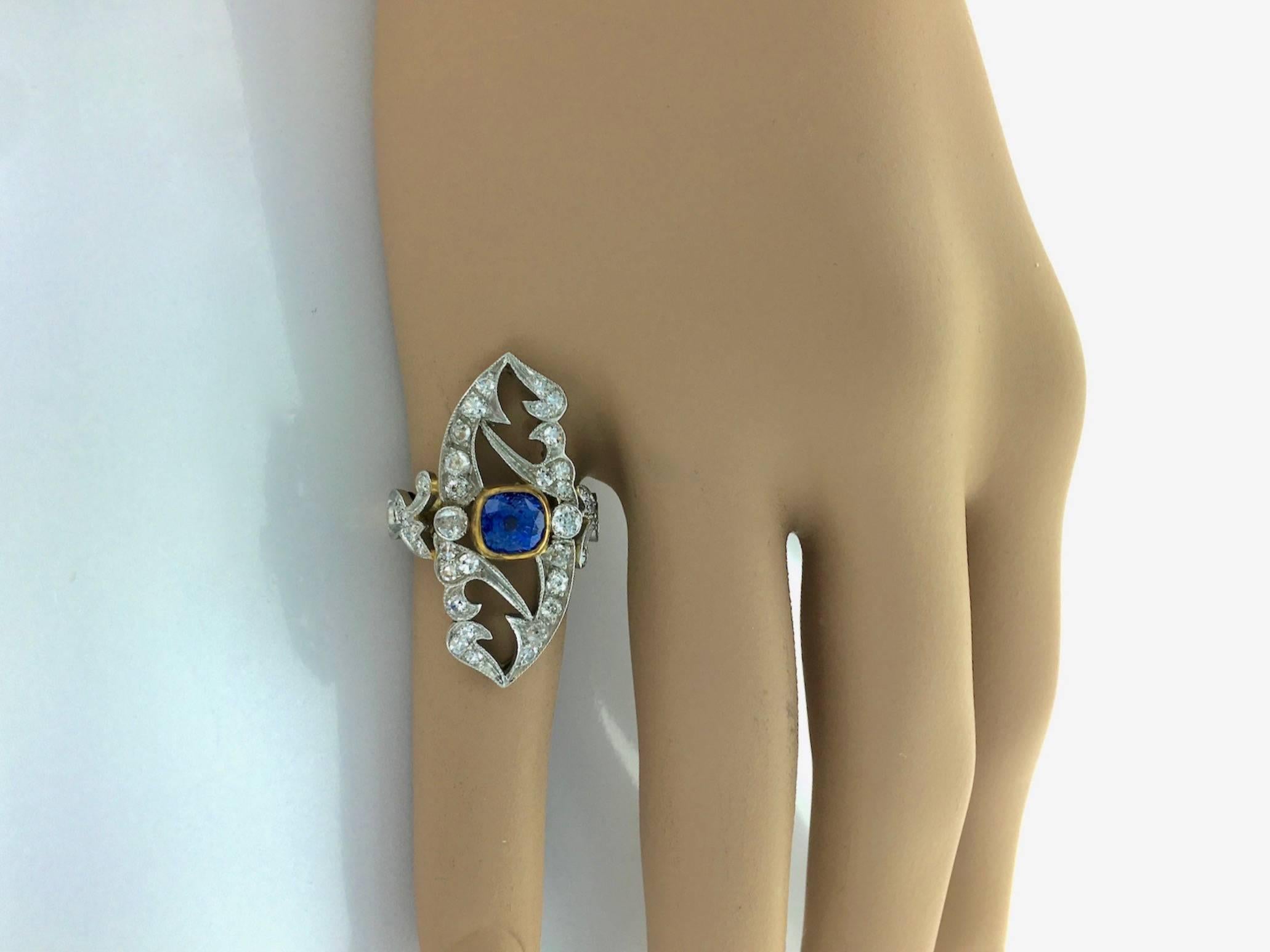 Incredible Art Nouveau design Platinum and Gold ring centered by a cushion blue Sapphire surrounded by Old-mine cut Diamond.

Gross weight: 7.37 grams.