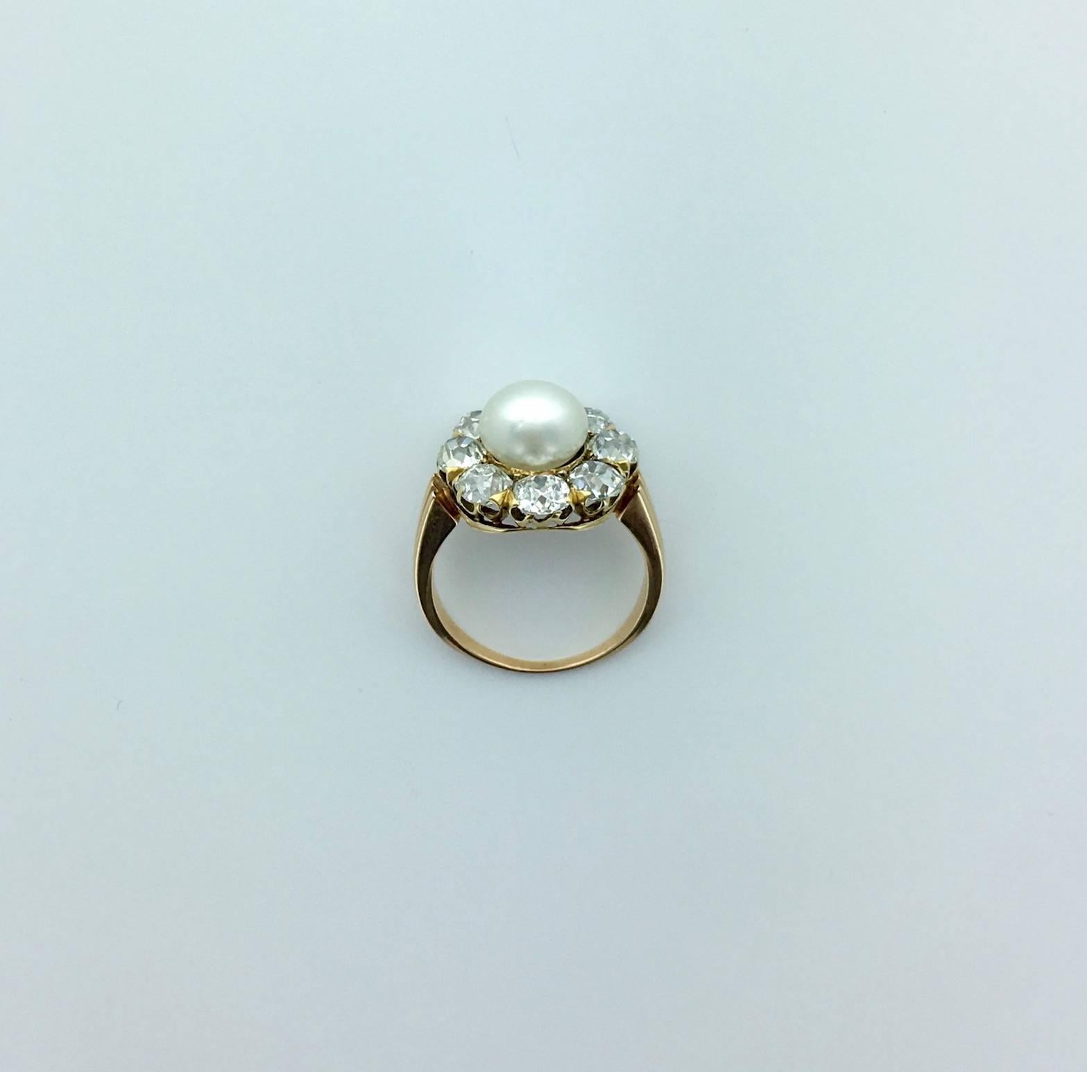 It looks like a candy. The centering Natural Pearl is surrounded by Old Mine cut Diamond (approximately 2.10 carats) on yellow gold.
Early XXth Century.
French mark.
Pearl's Measurements: 8.40x8.00 millimeters.

The Natural Pearl is accompanied by a
