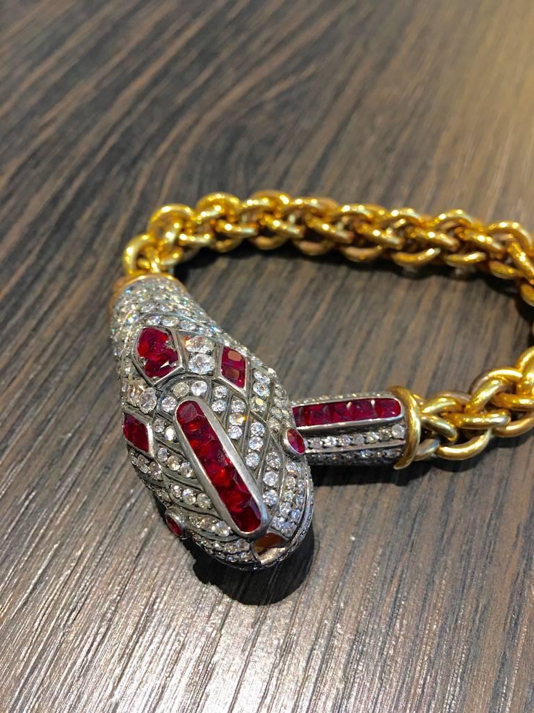 Unique Snake Bracelet. Strong and significant, the chain is in yellow gold 18k 750 and the Snake's head is in silver and gold engraved, all pave on the top by calibrated Rubies and Diamond.