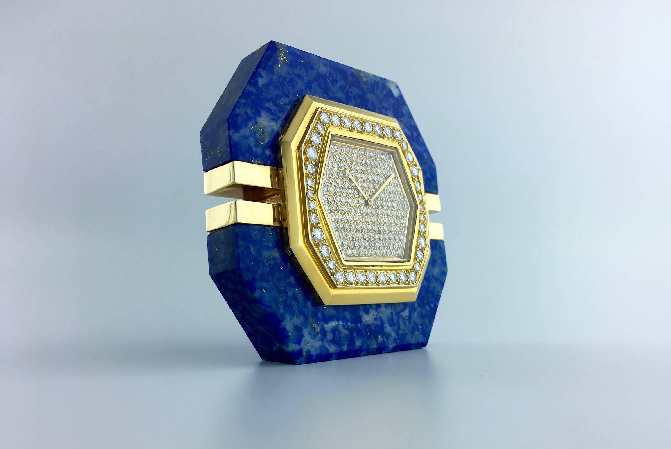 This Small Clock is striking by the shape and color combination.
Circa 1980 reminding Art Deco geometric design the Lapis lazuli is in perfect condition. The Blue is deep Royal. The gold is pave by round cut Diamond (G-H color and Vvs-Vs clarity)