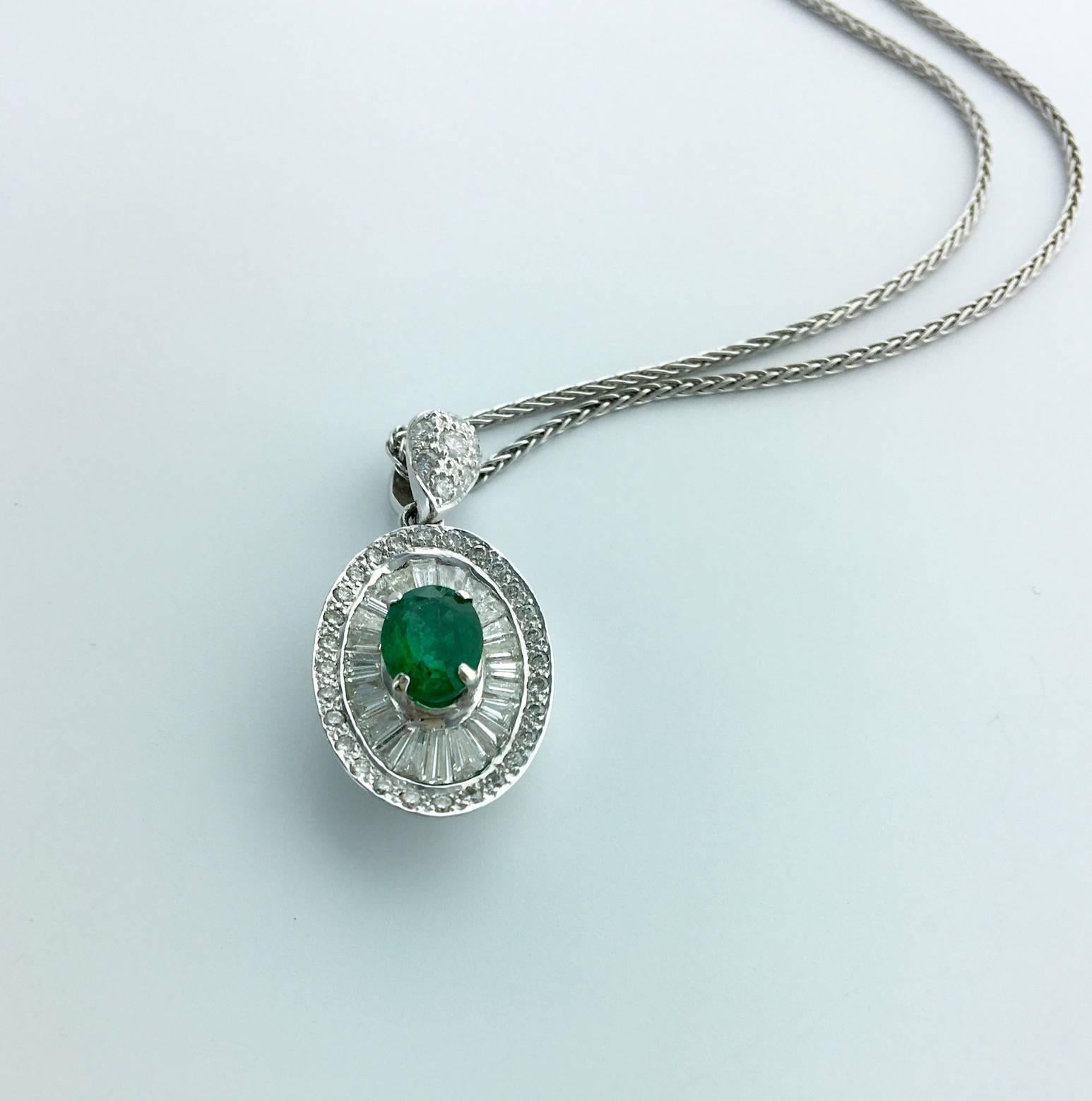 Beautiful Oval Green Emerald surrounded by Baguette cut and Round cut Diamond mounted on white gold 18k 750. 
Contemporary work.

The chain is in white gold.
The Pendant is  numbered.

Gross weight: 9.51 grams.