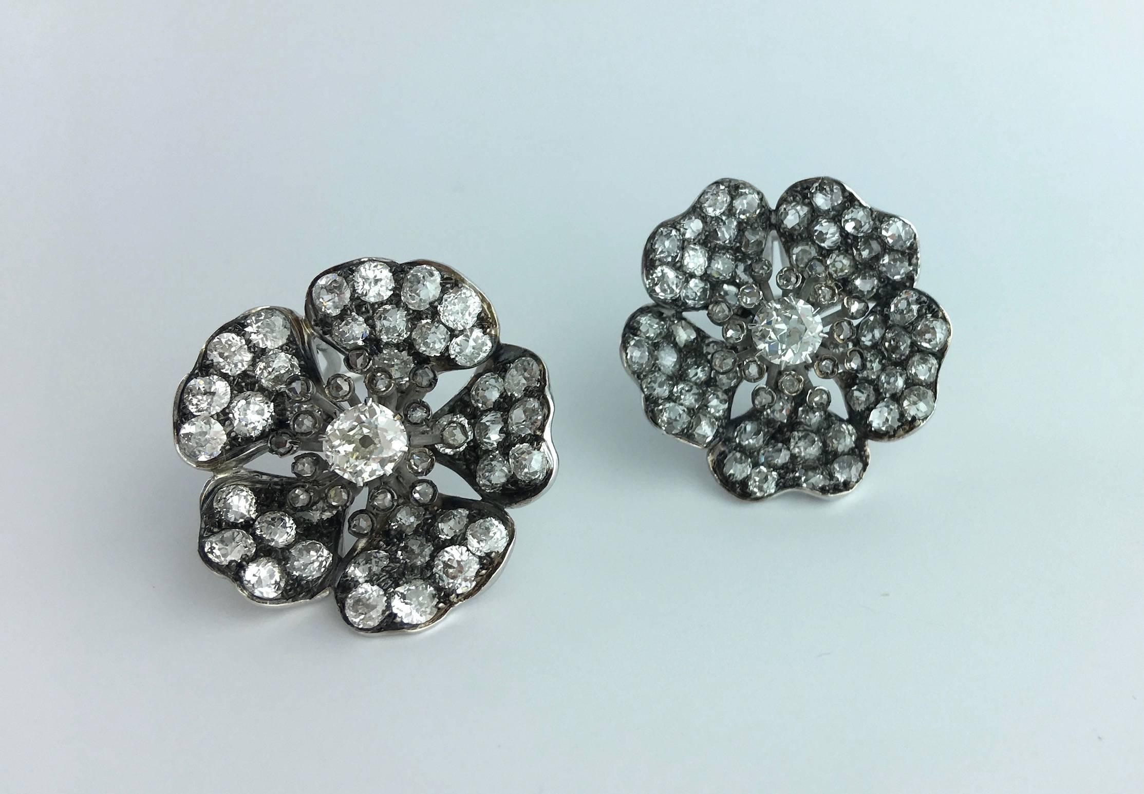 Those Flower Earclips are totally amazing!
Old mine cut diamond on gold and platinum. 
In our opinion approximately 7.00 carats total.

Gross weight: 18.57 grams.