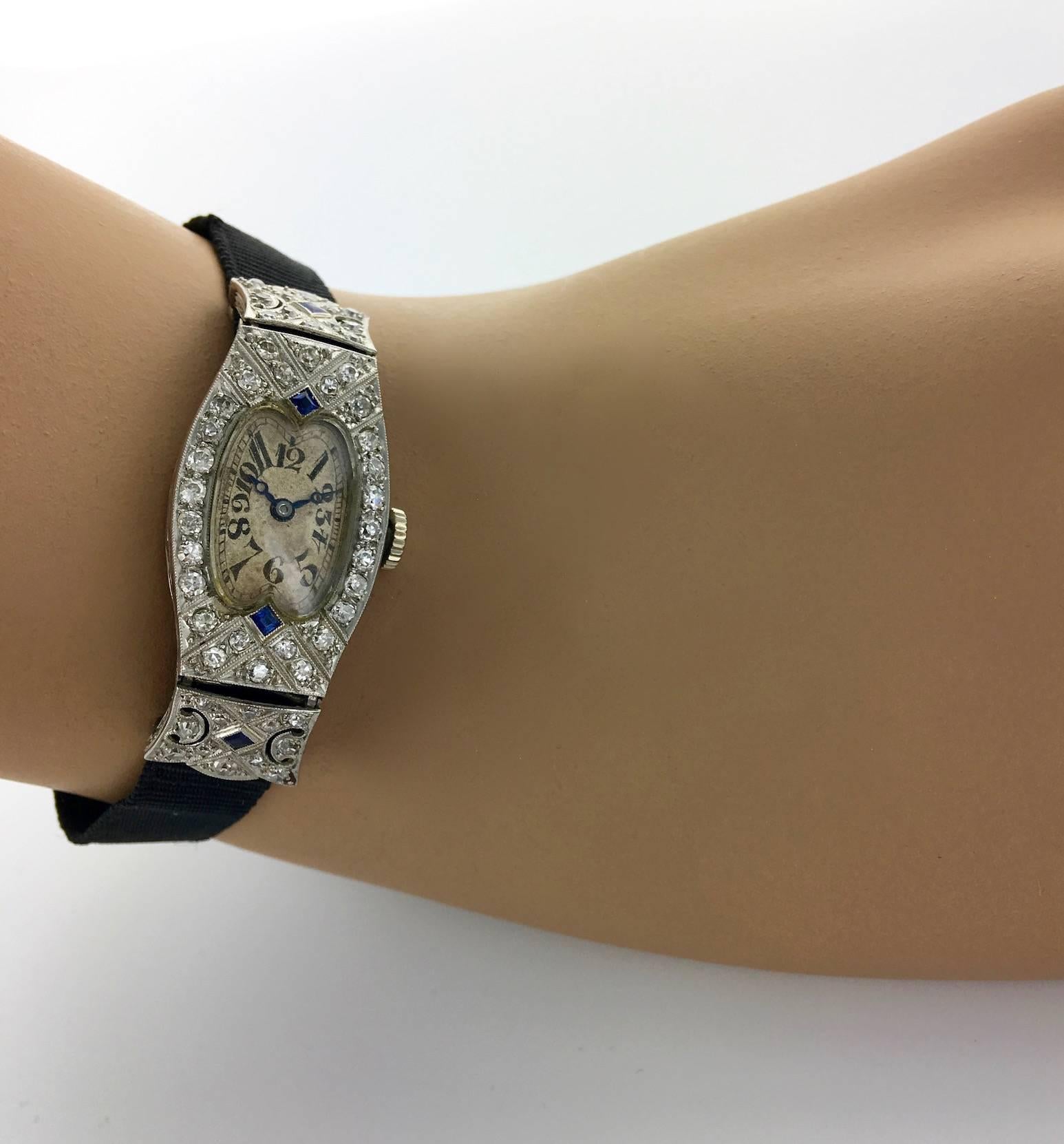 Art Deco Diamond and Sapphire Platinum wristwatch.
Glycine, 18 Rubies.
Made in SWITZERLAND. Circa 1920.
Black satin bracelet.