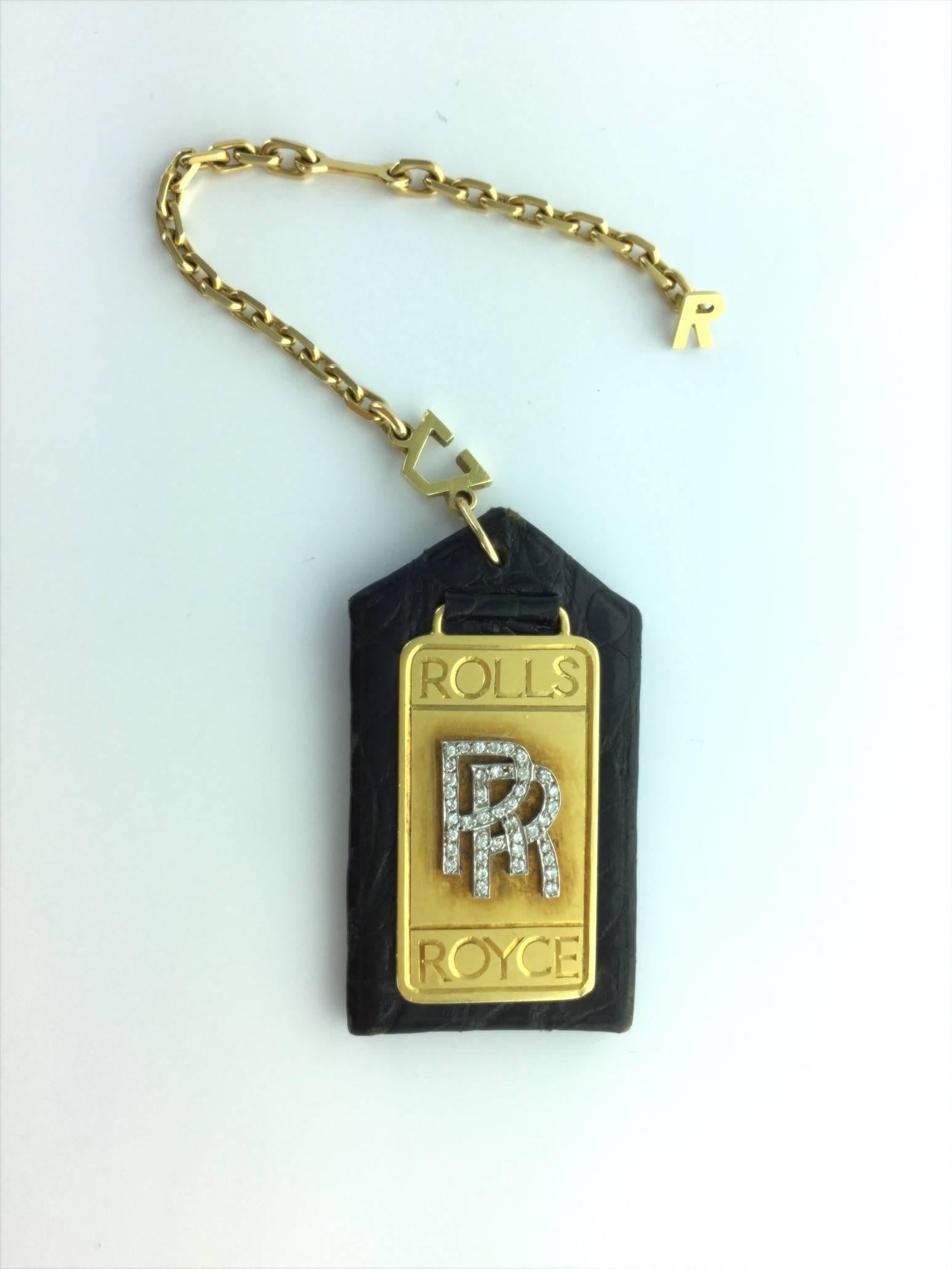 The perfect accessory for your Rolls Royce.
All yellow gold and platinum, the logo is set by diamond. 
Back in black leather.
Circa 1980.

Signed Alexandre Reza.
French assay marks and maker's mark.

Gross weight: 26.11 grams.