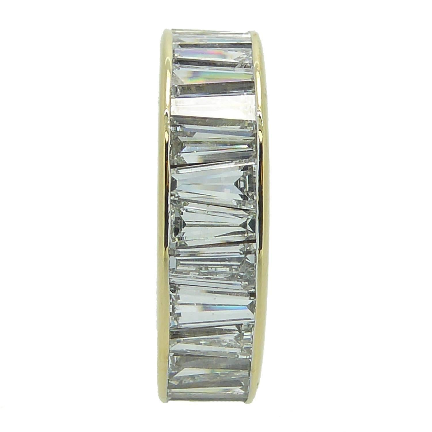 Magnificent eternity ring boasting approx. 4.0 carats of tapered baguette diamonds.  The diamonds are set into a channel of yellow metal in a full eternity style.  A truly fabulous display of diamonds that's just perfect whether worn as a