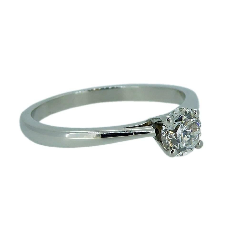 A classic single stone diamond; the perfect engagemen ring in platinum.  In a modern design, the diamond is four claw set in white to a basket style setting with shoulders tapering to a D shaped cross sectioned shank.  Hallmarked 950 grade platinum