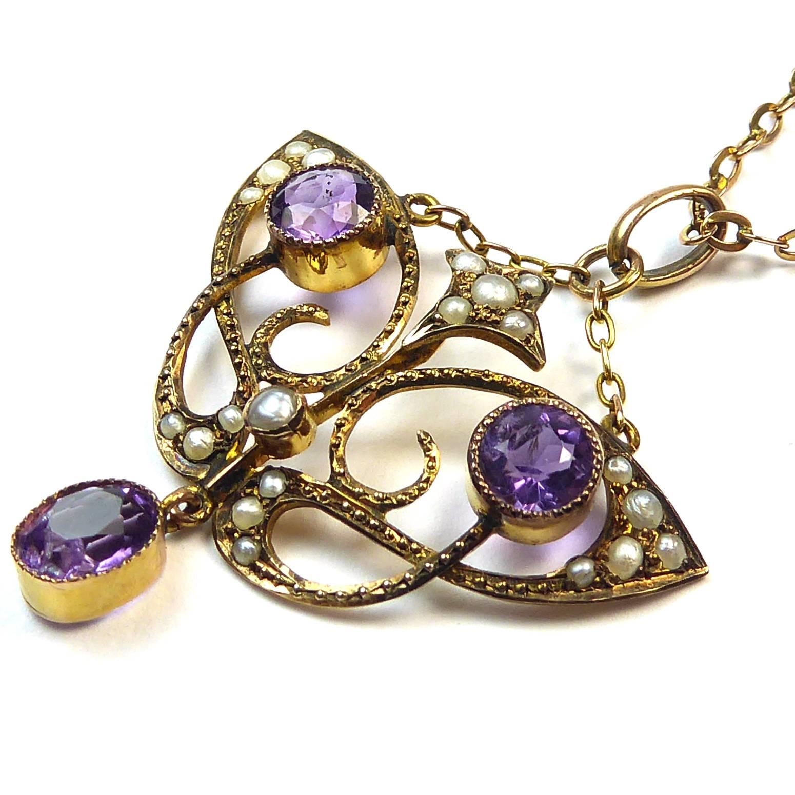 Gorgeous vintage necklace from the Art Nouveau period in a very stylized butterfly design.  Each 'wiing' is set with a rich purple amethyst with milled grain edges whilst curled around each of the gemstones is a flambouyant leaf design set with
