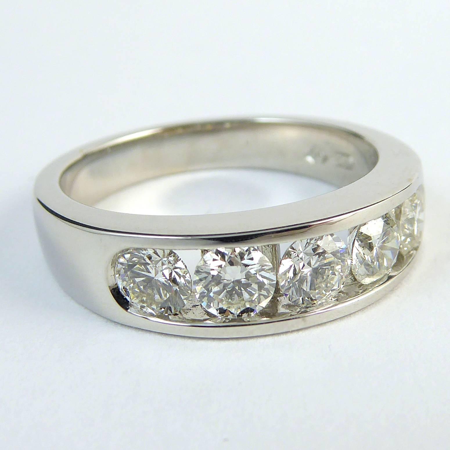 Fabulous wedding ring or eternity ring set with five brilliant cut diamonds approx 3.8mm diameter and with a total carat weight 1/03ct. Colour and clarity assessed as H/I and VS/SI.  The diaonds are in a channel setting to the front half of an 18ct