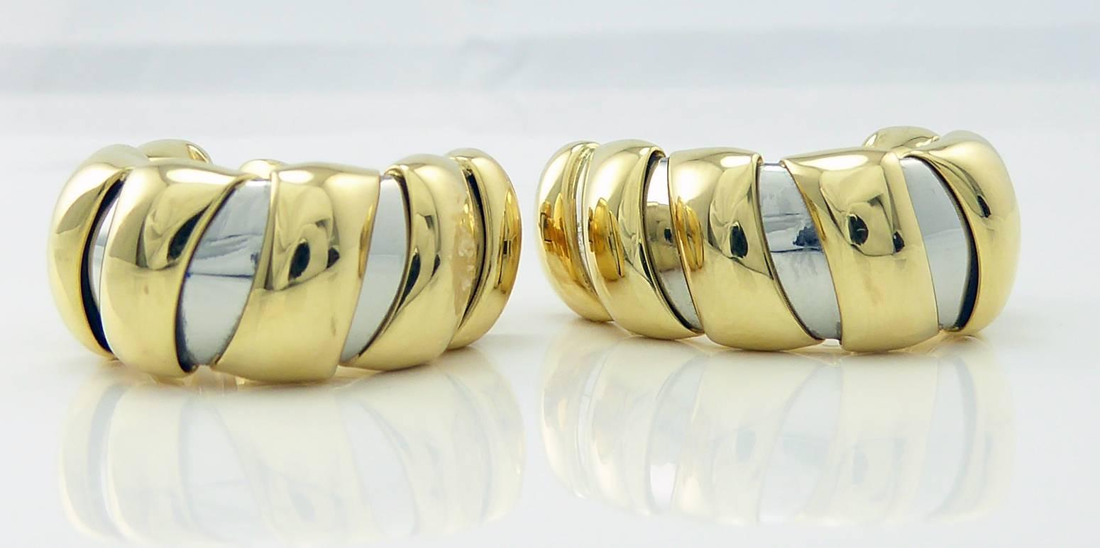 Classic hoop earrings from the 1980s by renowned jewellery designer Bulgari.  The earrings are oval shaped hoope of steel wrapped with 18ct yellow golds bands approx. 6.5mm wide.  Perfect as an everyday earring for down time or workday.
