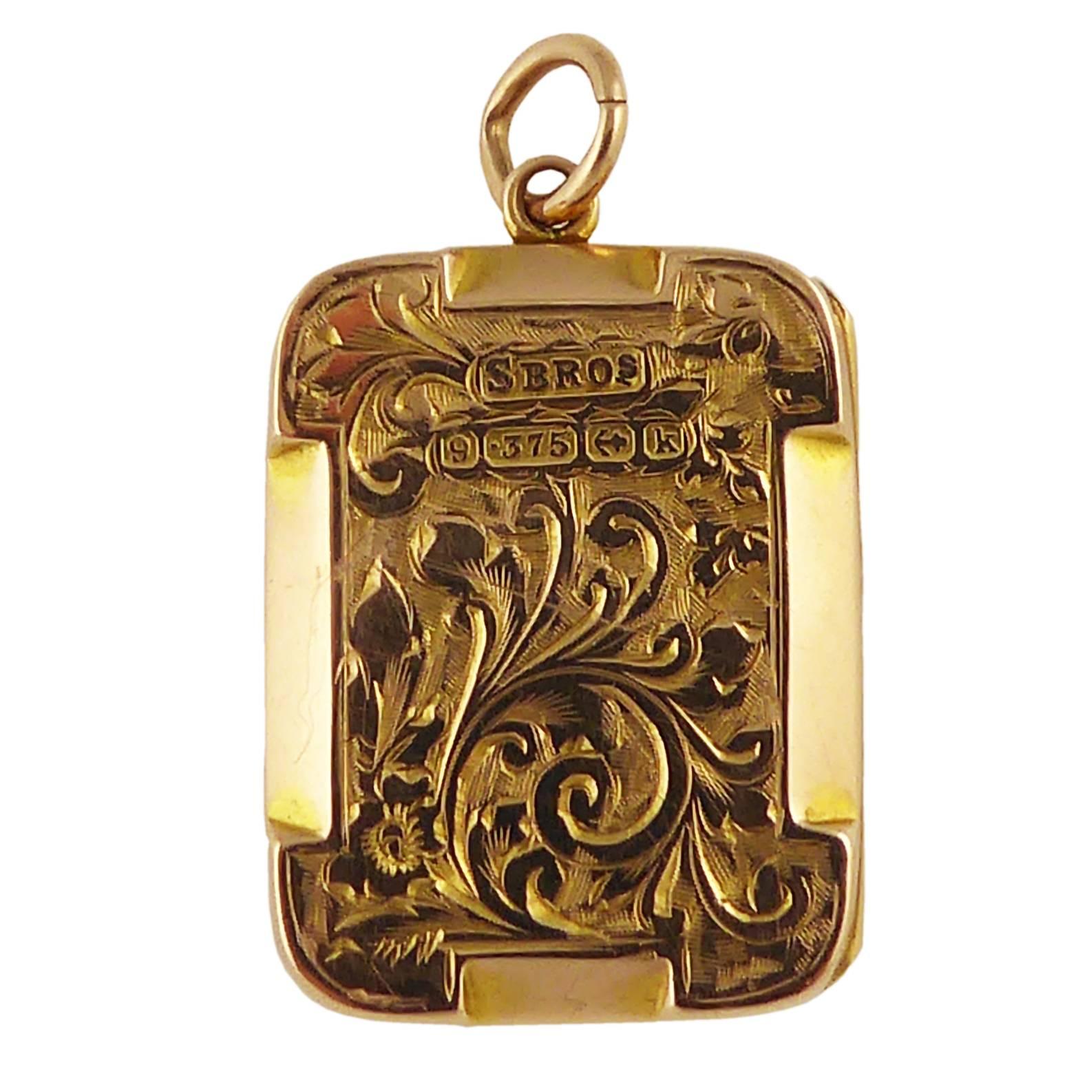 Beautifully hand engraved in a floral and scroll work pattern, this antique locket dates from 1909.  The overall square shape is softened by the rounded corners.  It stands apart fron the more often seen locket by its chamfered details to the edges.