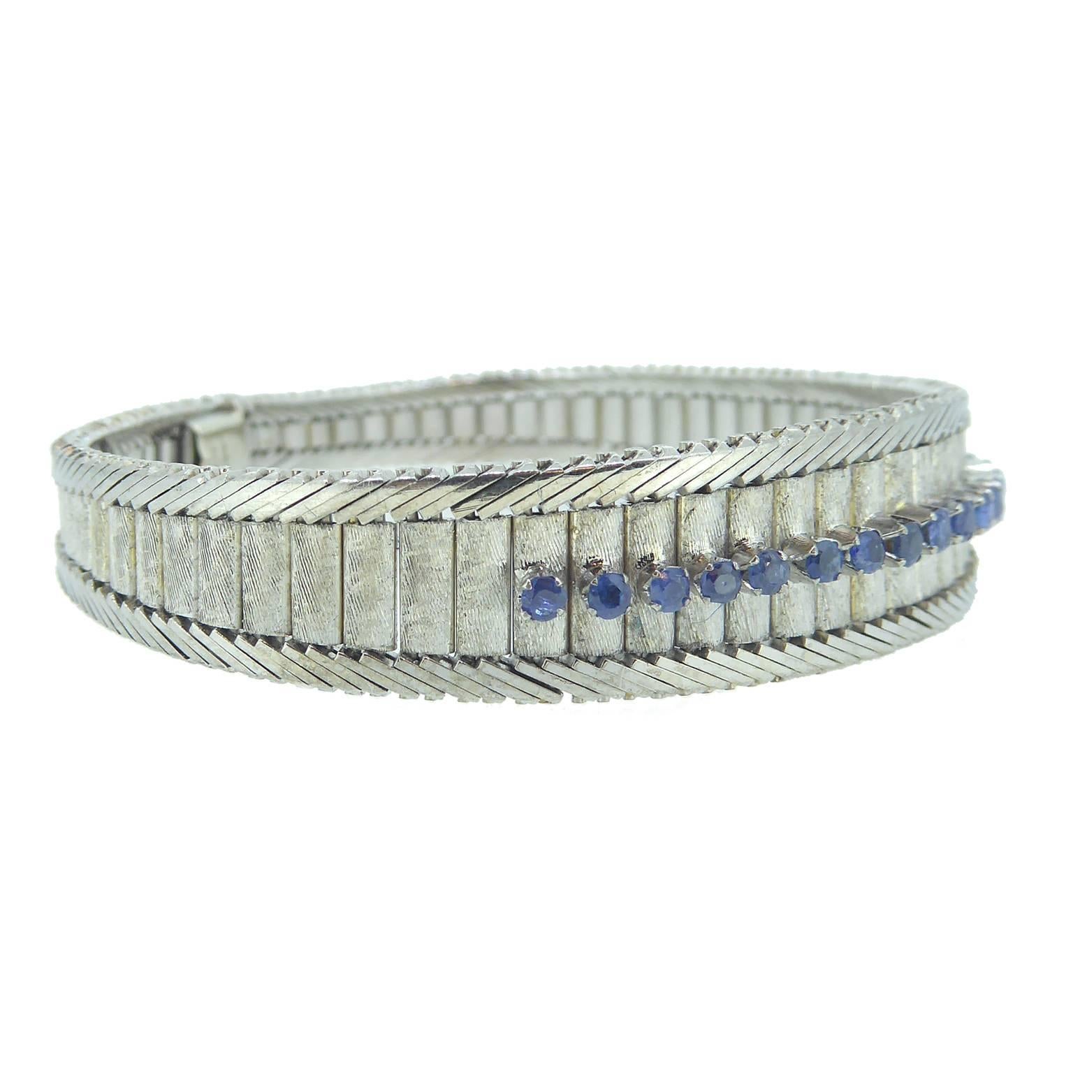 Perfect for evening or smart day wear and a pretty alternative to a diamond line bracelet.

A sapphire line bracelet in 18ct white gold with a plain polished and brushed finish comprising rectangular white links with a brushed finish measuring from