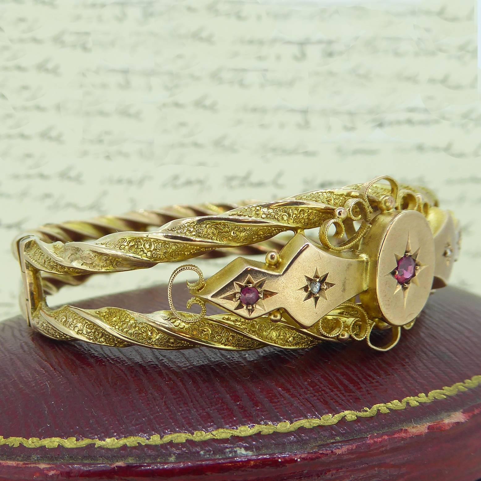 A stunning Victorian bracelet featuring a central oval panel set with a round mixed cut ruby.  To either side is diamond shaped pane set with an old rose cut diamond and a further panel set with a ruby.  All the rubies and diamonds in the front of