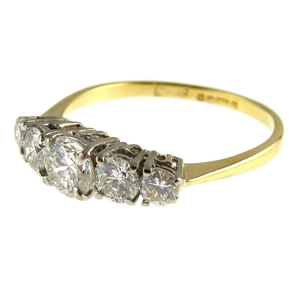 A really lovely 5 stone diamond ring that works perfectly as an engagement ring or eternity style band.  The diamonds are all round brilliant cut stones and they sparkle very well in their white four claw mounts.  The band is 18ct yellow gold which