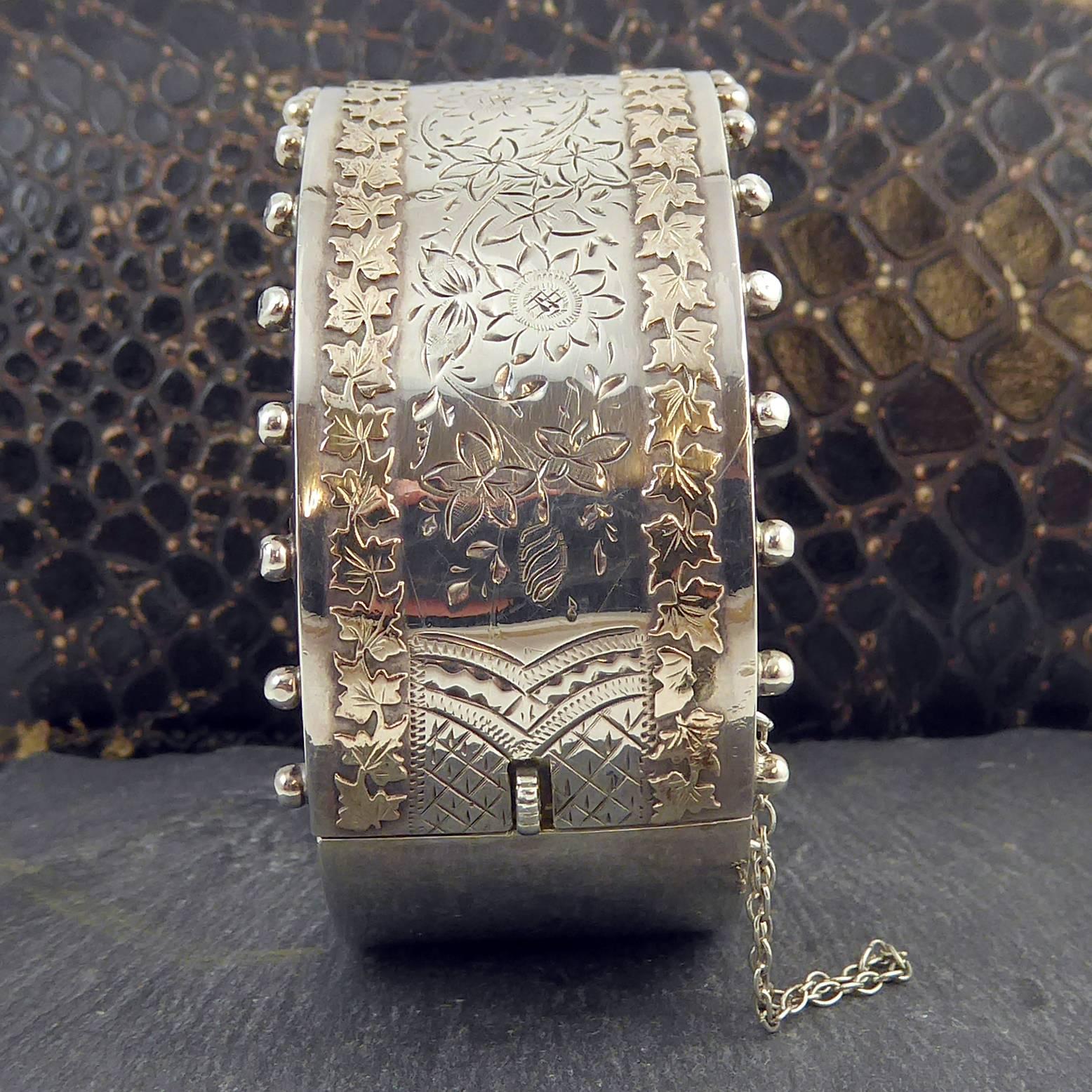 A fabulous Victorian silver cuff bangle hallmarked at the Birmingham Assay Office in England in 1884.  The design is bold and eyecatching in a cuff style which would look sensational worn over a fine wool sweater.

Silver beads are evenly spaced