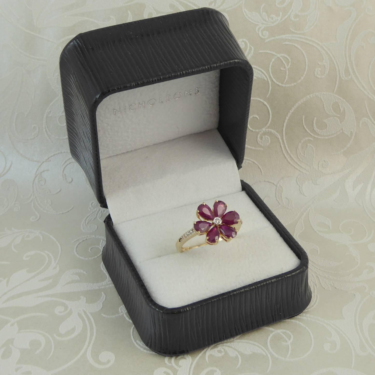 A vintage ruby and diamond cluster with with a very pretty spin on the daisy design being set with rubies as opposed to the more often seen diamonds.  It is a very neat design and makes a perfect dress or cocktail ring for the petite hand.  Cute and