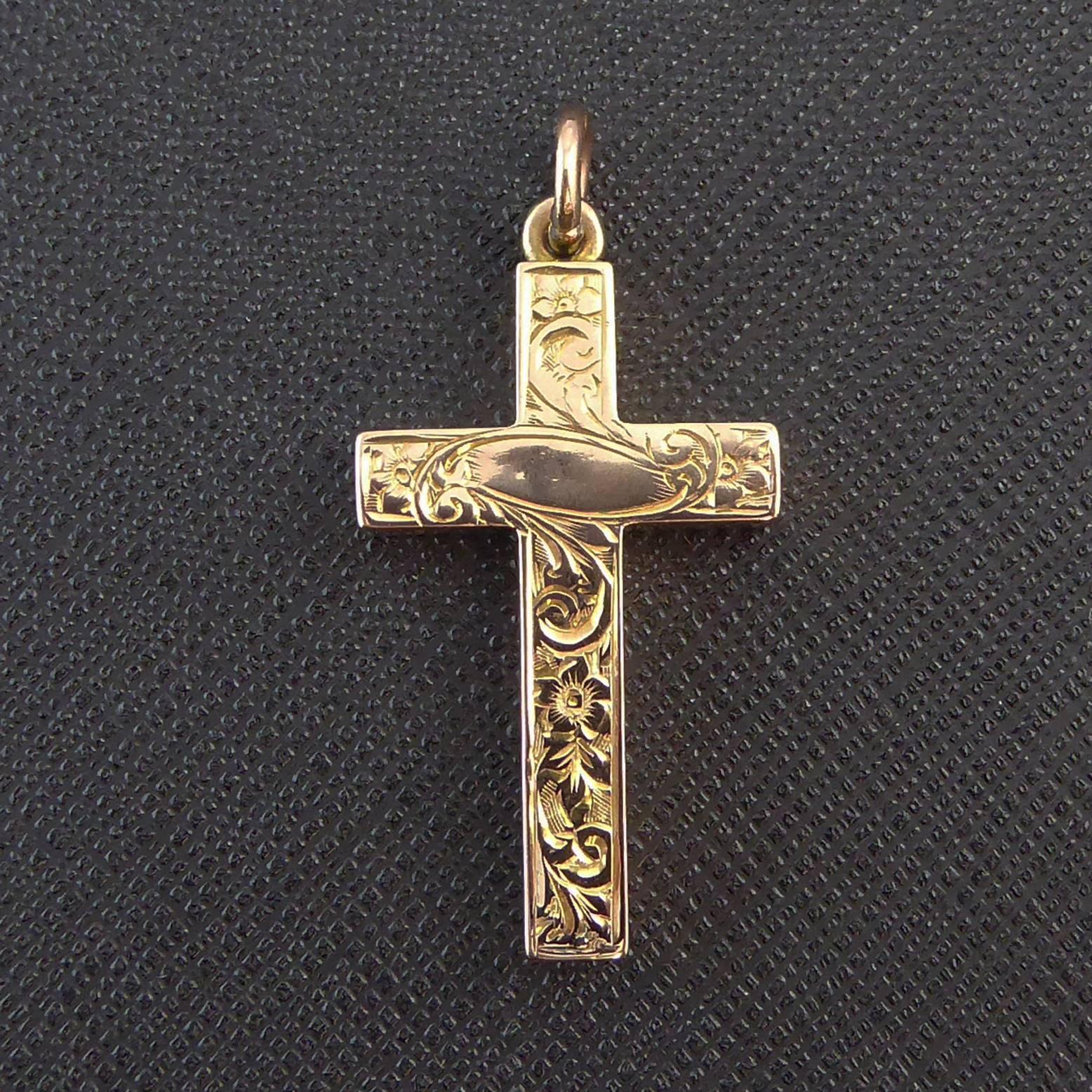A delightful antique gold cross created in the English Edwardian era of rose gold.  The beautiful and intricate hand engraved pattern has been applied to both sides of the cross and each side also has a plain polished cartouche.  The cross is a