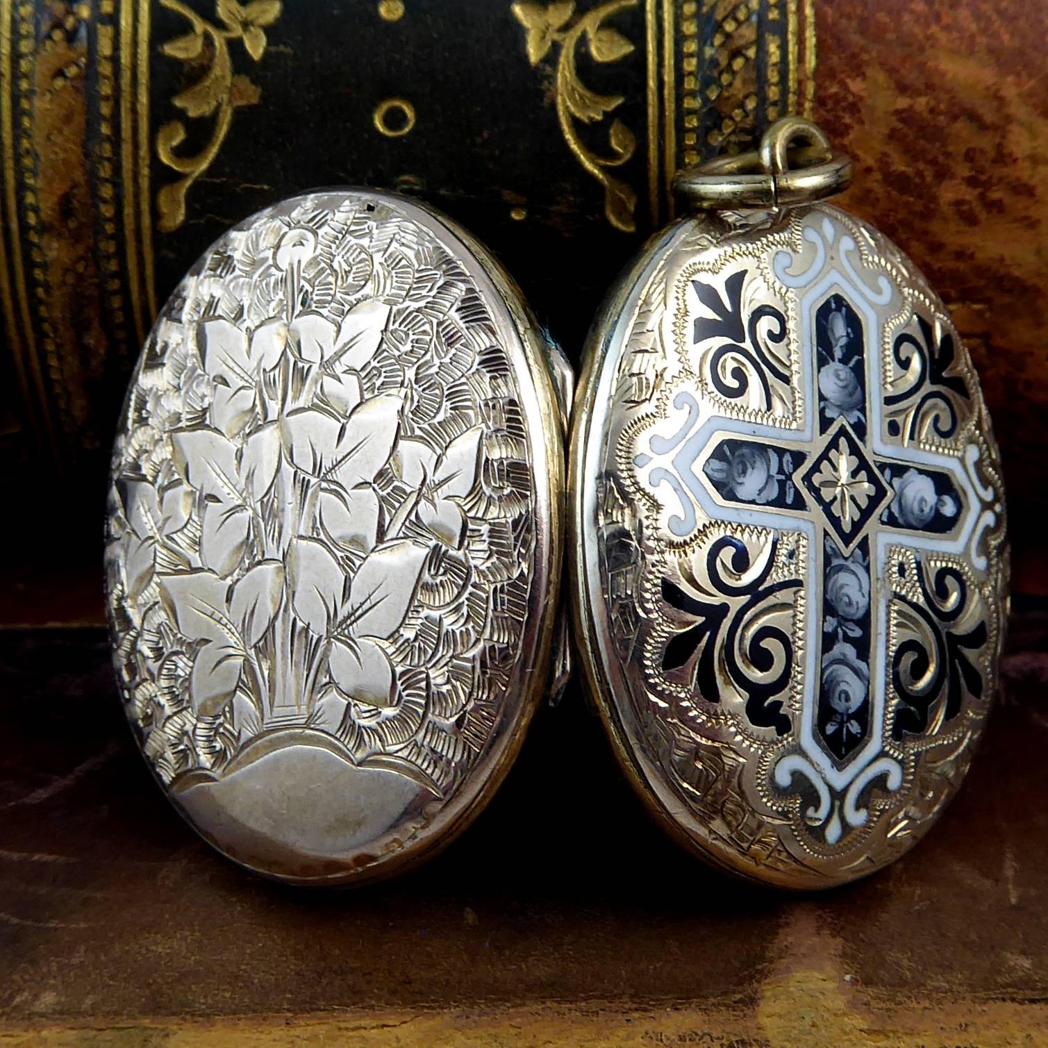 An antique locket created from 9ct yellow gold to the back and front with exquisite engraving to both sides.  Additionally, the front of the locket has been handsomely enamelled with a dark bluish/black, white edged cross which is decorated with