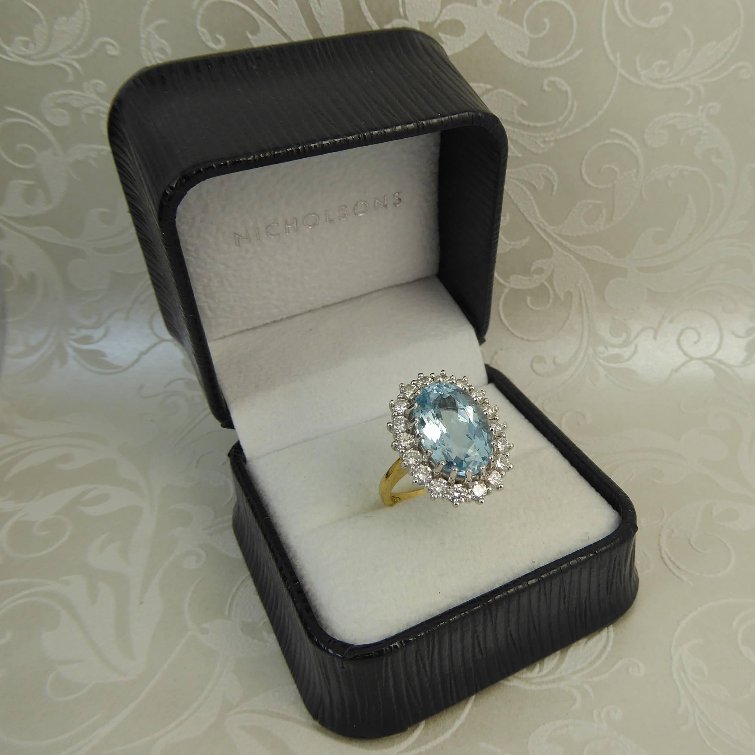 A fabulous blue topaz, medium to dark blue in tone and weighing 8.91 carat sits within a diamond halo to create a cluster cocktail ring of impressive proportions which looks sensational on the hand.  The topaz is an oval mixed cut measuring approx.