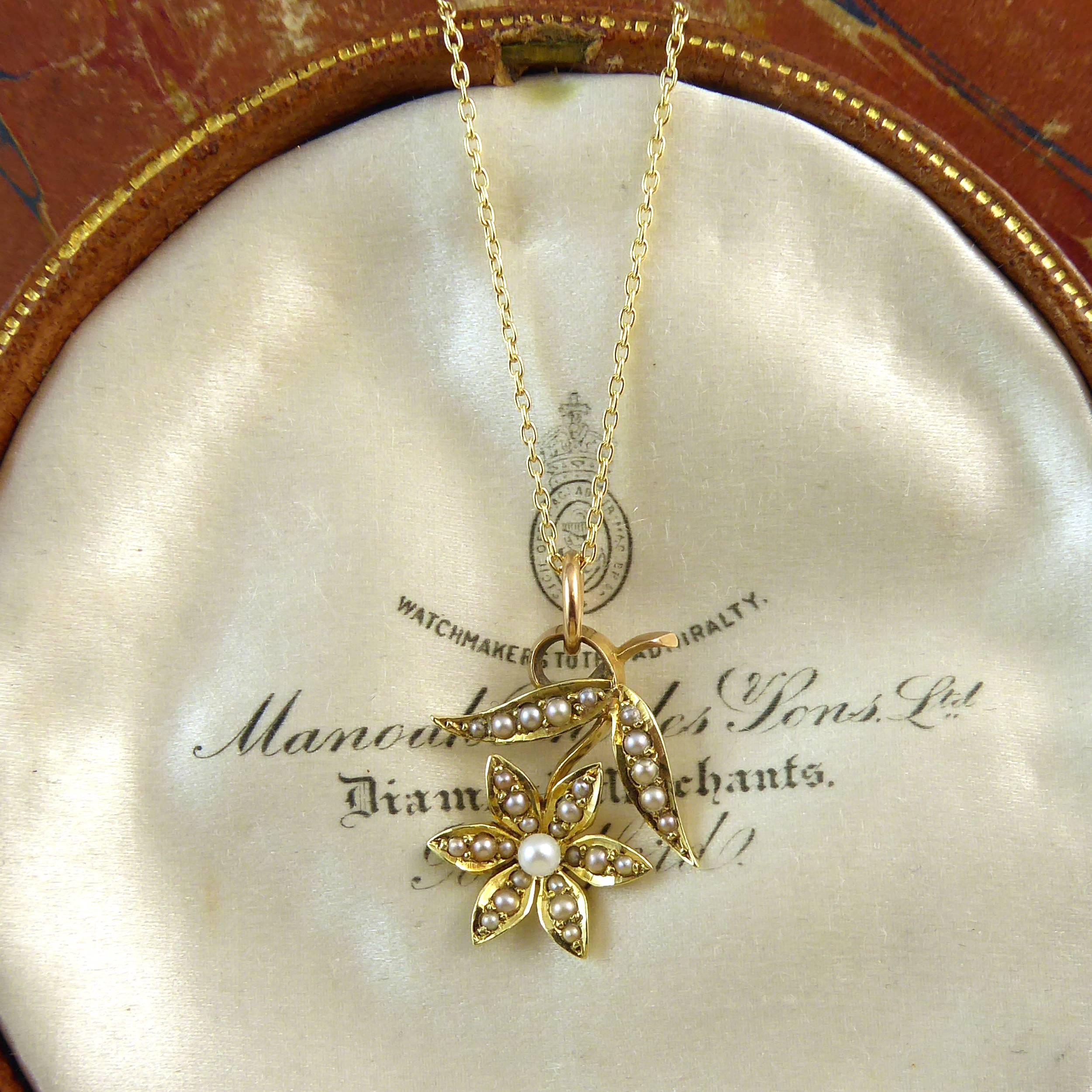 Delightful Victorian pearl pendant created in 15ct gold of a flower and leaf design all set with lustrous creamy white pearls.  The pendant is dainty and feminine and would be perfect to be worn on many occasions throught life and an ideal gift for