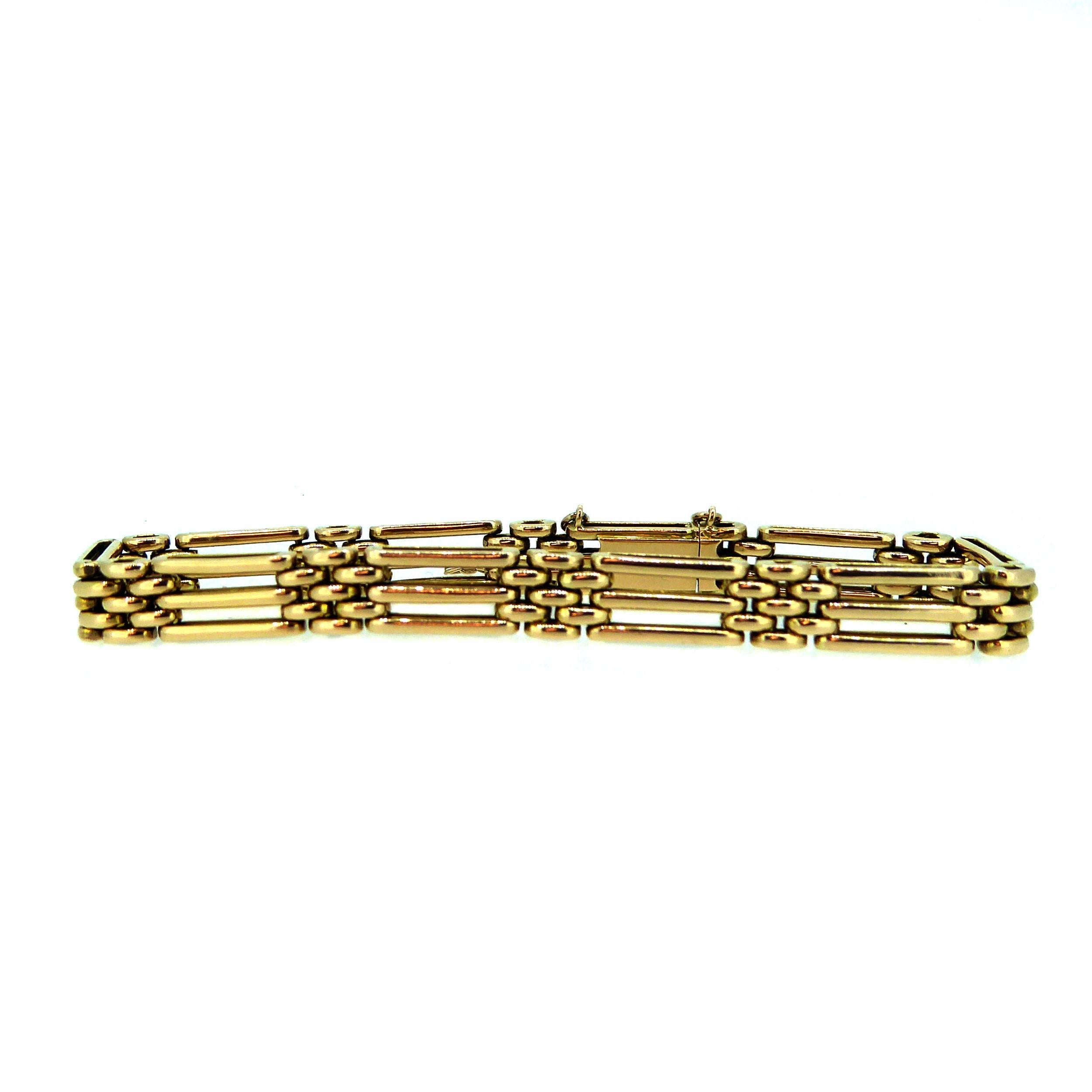 Antique gold bracelet in the popular 'gate' style having 10 'gates' of three plain polished, rounded oblong links approx. 0.5 inch long.  Each of the gates is connected by rounded links in a brick-work pattern approx. 0.38 inch long. The total