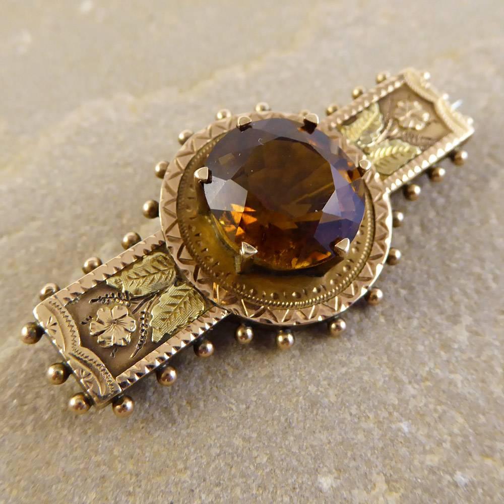 This beautiful Victorian brooch is set with a stunning smoky Quartz in an intricately designed two colour 9ct gold setting. With foliage detailing, it looks classic and stylish when worn!

Condition: Very Good, small chip on edge of stone (see