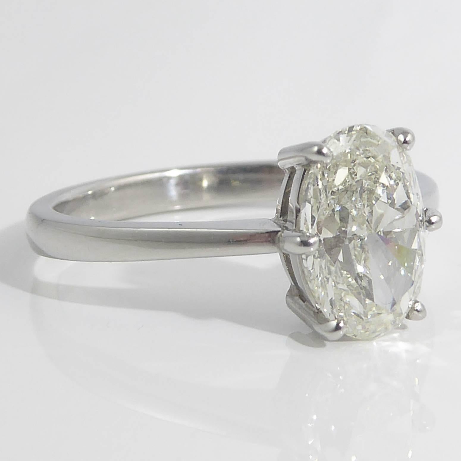 Fabulous oval shaped brilliant cut diamond in a solitaire diamond ring setting.  Six claws hold the diamond onto an open dual band gallery which allows the maximum light to disperse through the facets of the stone The band is a slight D shaped