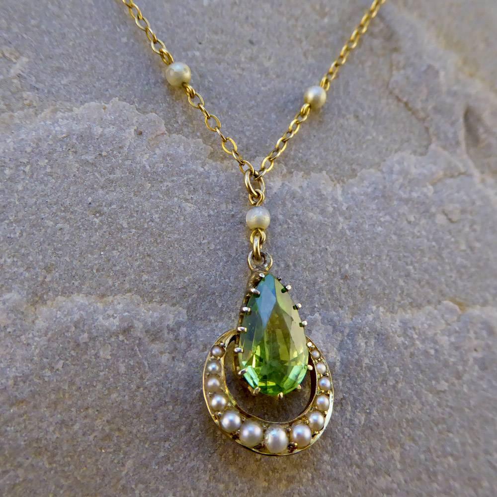 This Edwardian Necklace features Peridot, the August Birthstone, surrounded by Classic Seed Pearls. The Chain and Pendant are crafted in 9ct Yellow Gold.
It sits delicately on the collar bone, a truly timeless treasure!

Condition: Very Good,