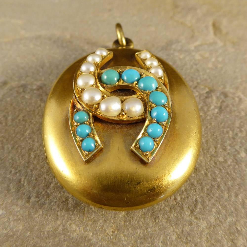 This striking antique pendant features a double horseshoe motif in pearls and turquoise stones. Modeled in 15ct yellow gold, it opens to reveal a secure compartment!

This Victorian piece will add a pretty pop of colour to any outfit!

Condition: