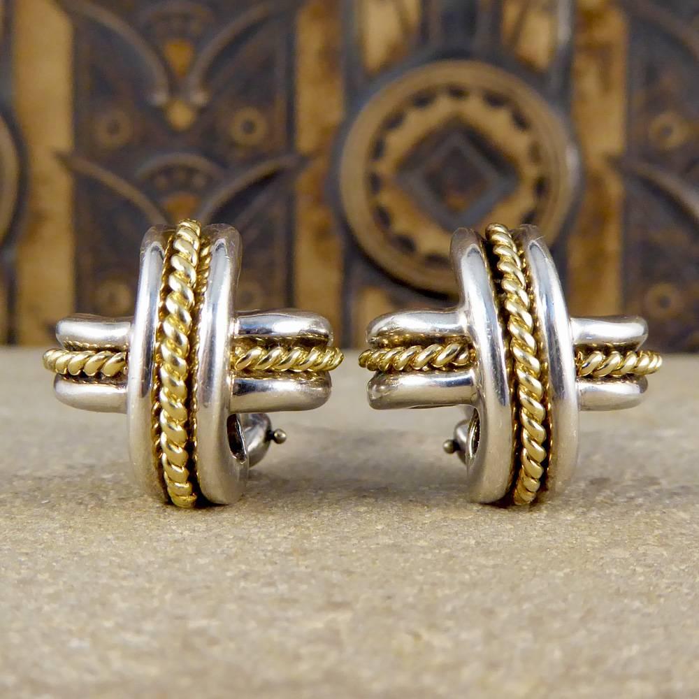 These vintage Tiffany & Co earrings have been stylishly designed in a domed cross weave pattern in silver with 18ct yellow gold twist detailing. 

Crafted in 1990, they will make a fabulous addition to any jewellery collection!

Condition: Very
