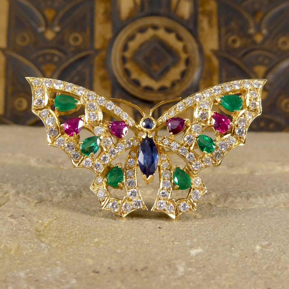 This fascinating brooch features a butterfly with a double sapphire stone body and diamond, ruby and emerald wings. 

A colorful beauty modeled in 18ct yellow gold, it is sure to make a great addition to your animal jewelry collection!

Condition: