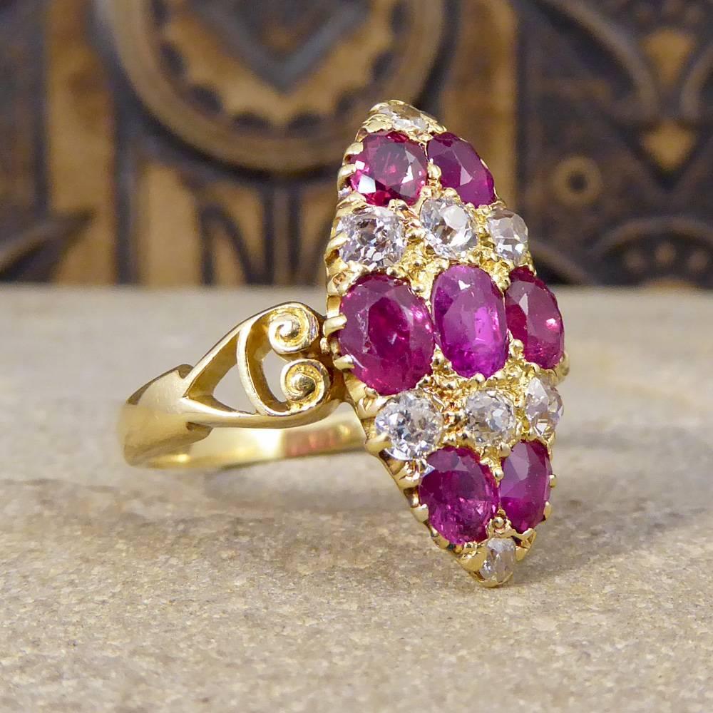This late Victorian ring is grain set within an 18ct Yellow Gold marquise shaped bezel. Holding seven Rubies graduating in sizes with a total of 1.90cts separated in layers by eight old cut Diamonds, ranging in size and colour from 0.03ct to 0.12ct,