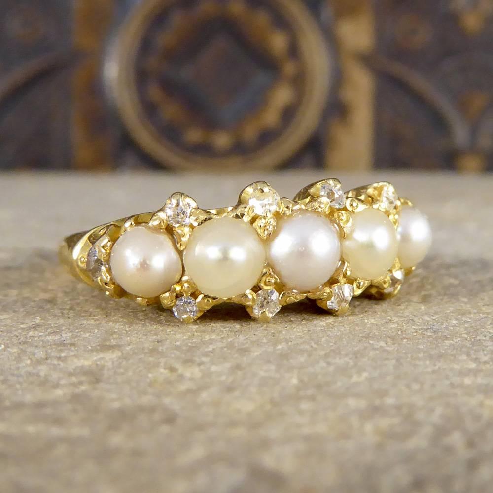 Stunning ring set with five pearls of slightly different colours, two being lighter and three with a slight grey tint. Alternating these Pearls, with the centre and outer Pearls slightly darker makes this Victorian piece just that more admirable,